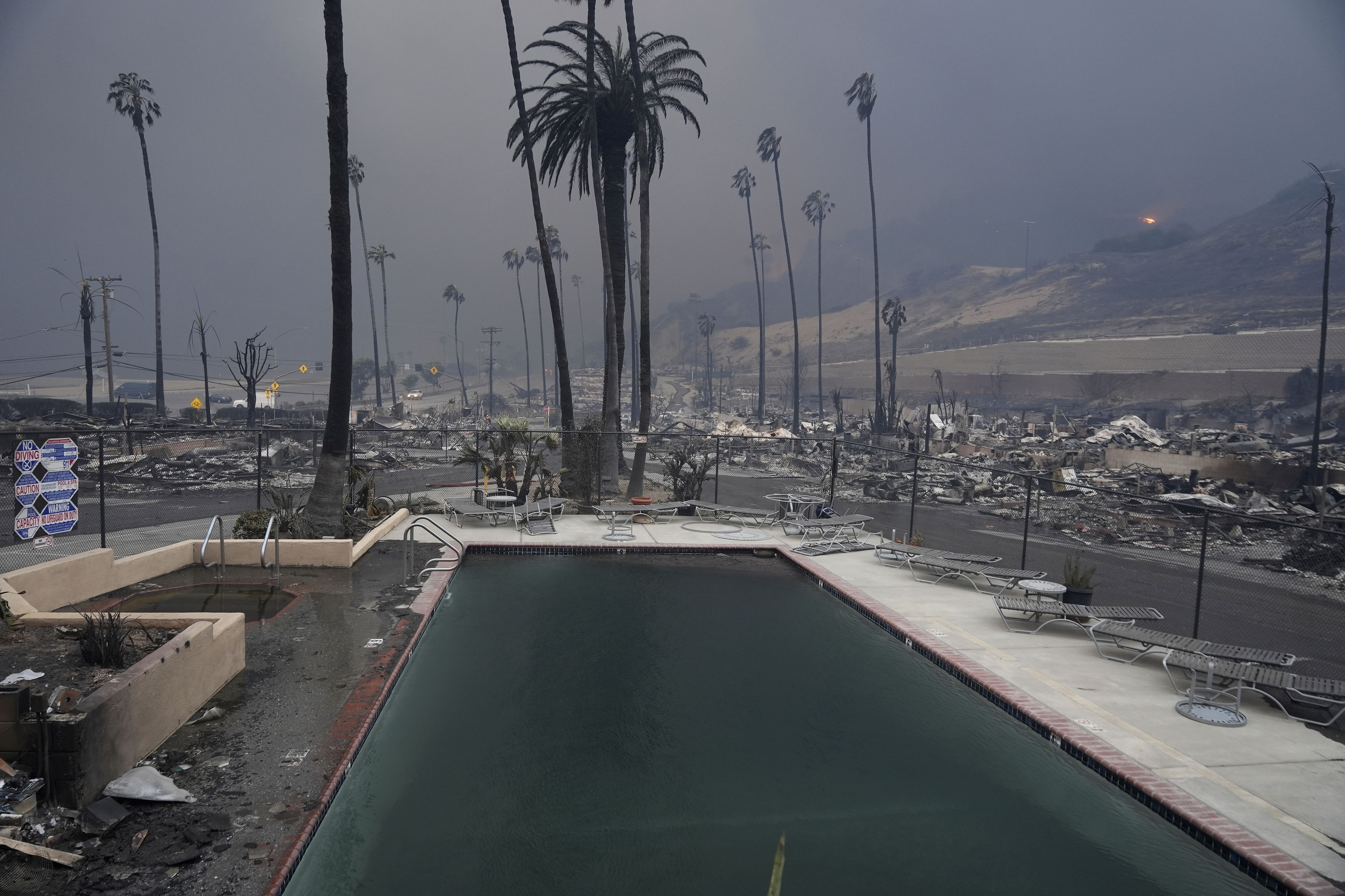 A wildfire-ravaged property is shown after the Palisades Fire swept through in the Pacific Palisades neighborhood of Los Angeles, Wednesday, Jan. 8, 2025. (AP Photo/Damian Dovarganes)