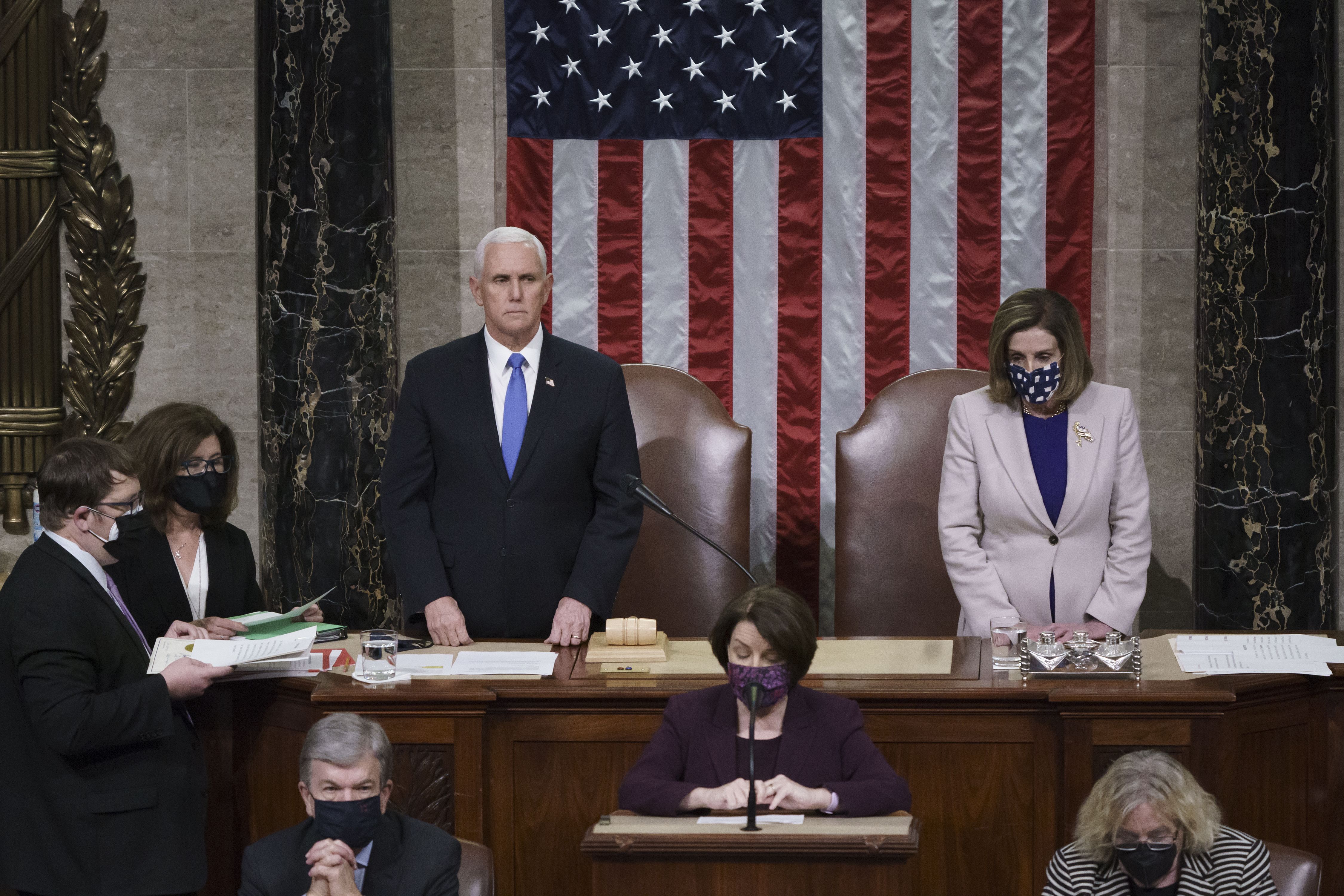  Vice President Mike Pence and Speaker of the House Nancy Pelosi, D-Calif., read the final certification of Electoral College votes cast.