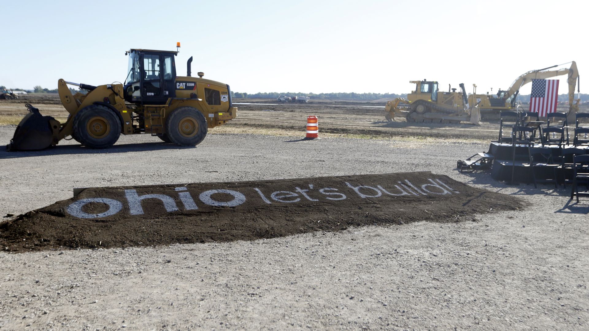 A tractor at the Intel construction site in Ohio, with letters on dirt reading "Ohio let's build."
