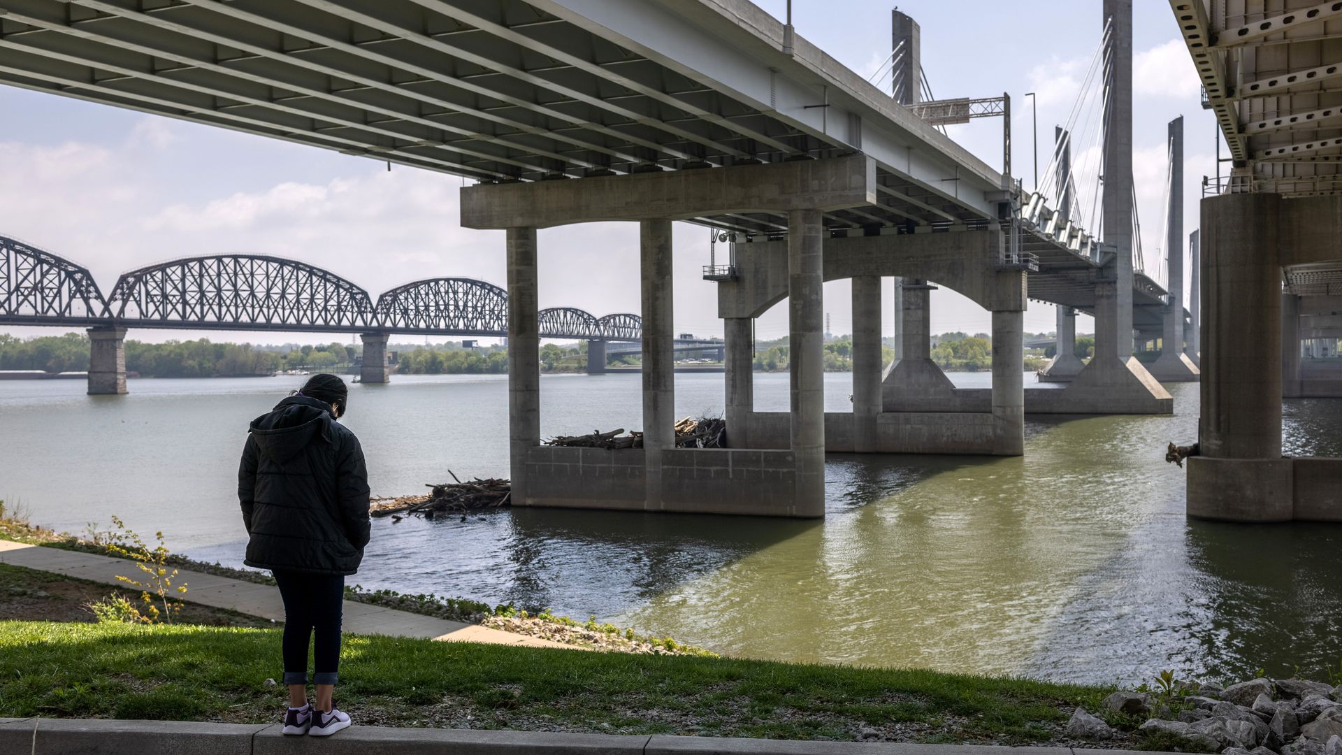 A migrant child sent on to the United States after her mother was expelled under Title 42 is seen looking out at a river in Indiana.