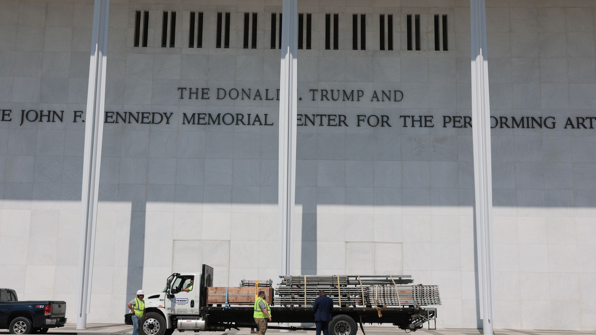 A truck with construction equipment parks below the sign for the Donald J. Trump and John F. Kennedy Memorial Center for the Performing Arts on June 12, 2026 in Washington, DC.