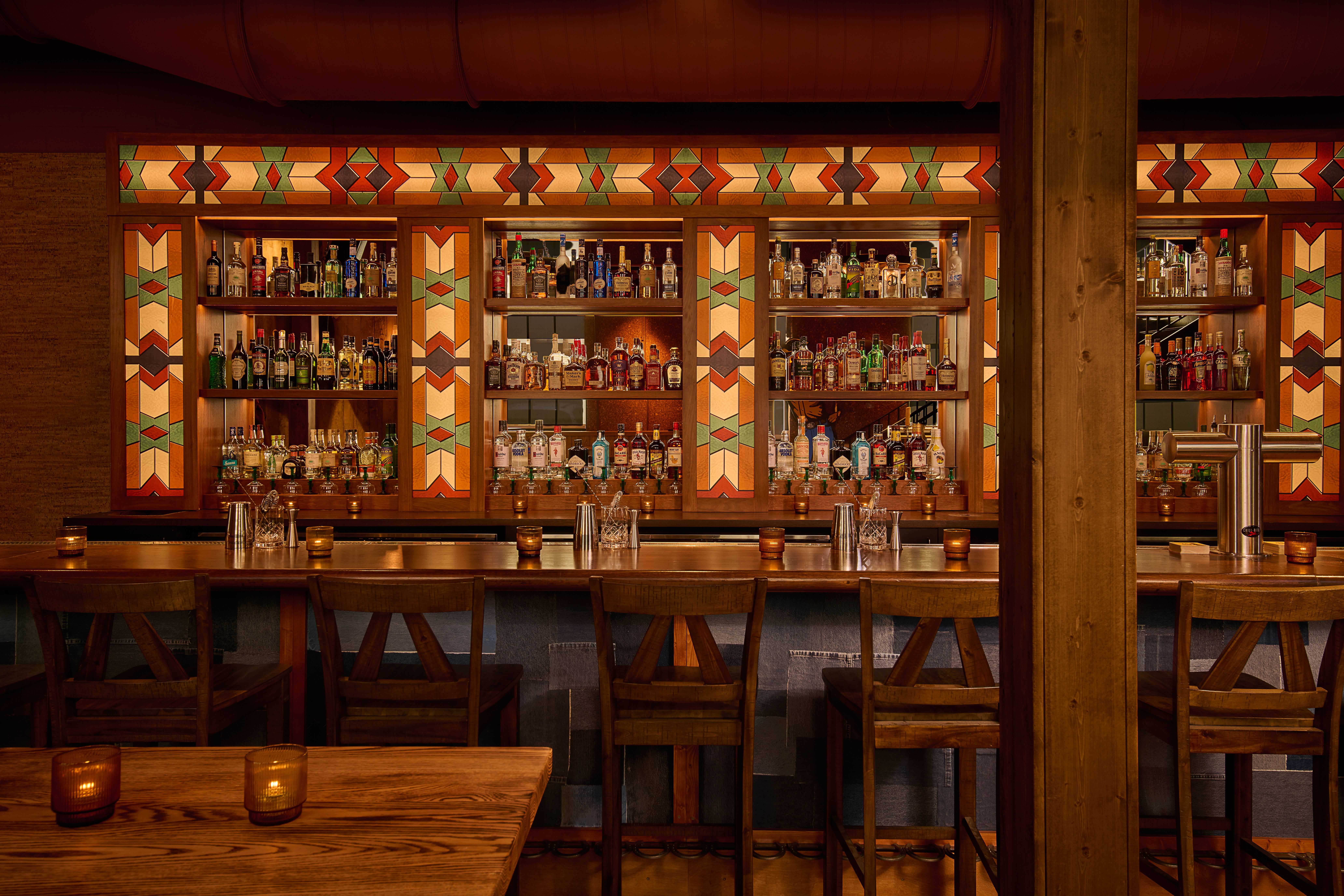 A Western-style bar with red, white and green lights and wood paneling