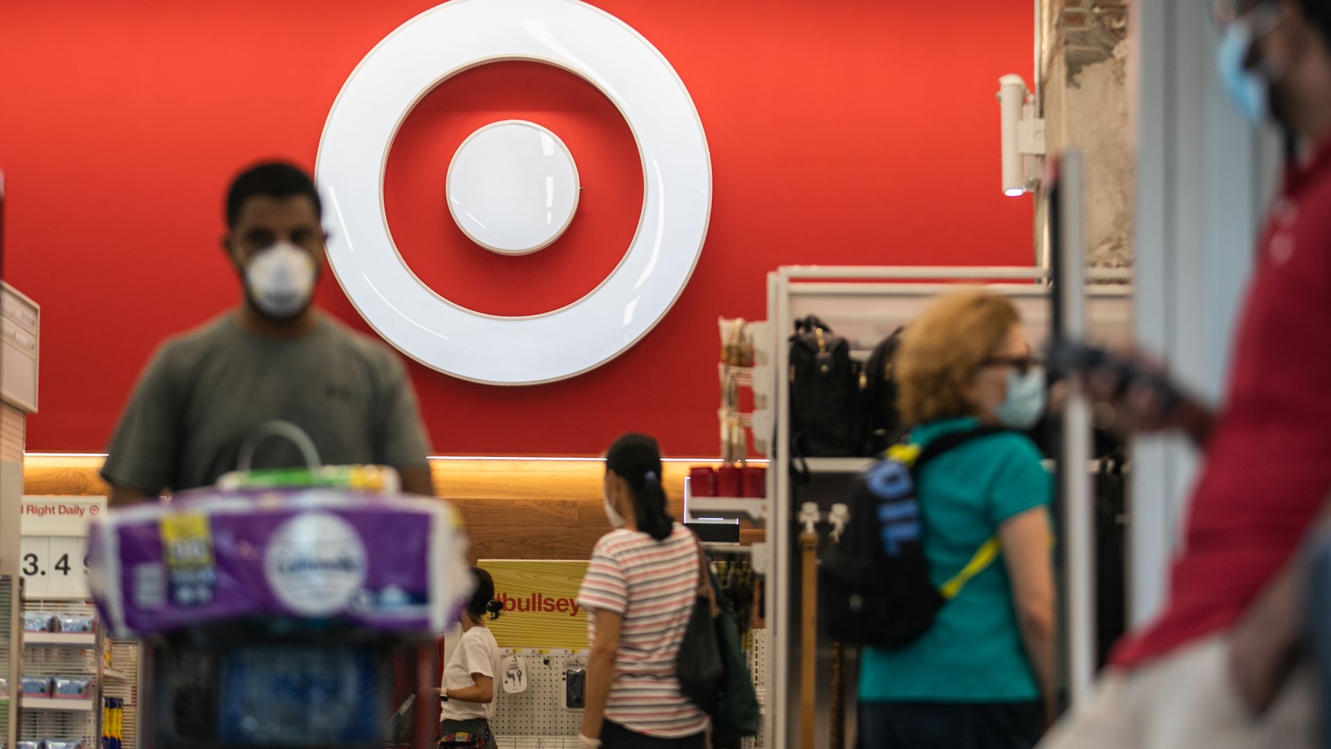 Shoppers in a Target store wear masks 