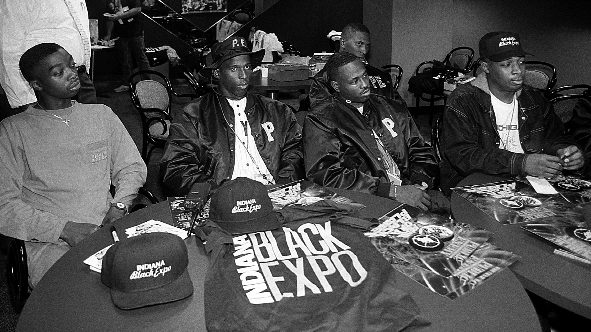 Comedian Chris Thomas (left) and rapper Chuck D. (right) of Public Enemy, flanked by the S1W's (Security Of The 1st World) greets the press during a press conference for Indiana Black Expo backstage at Market Square Arena in Indianapolis, Indiana in July 1990. 