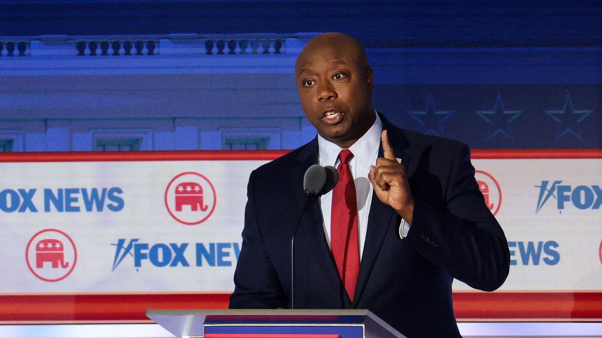 South Carolina Sen. Tim Scott speaks behind a podium at the first GOP presidential debate.