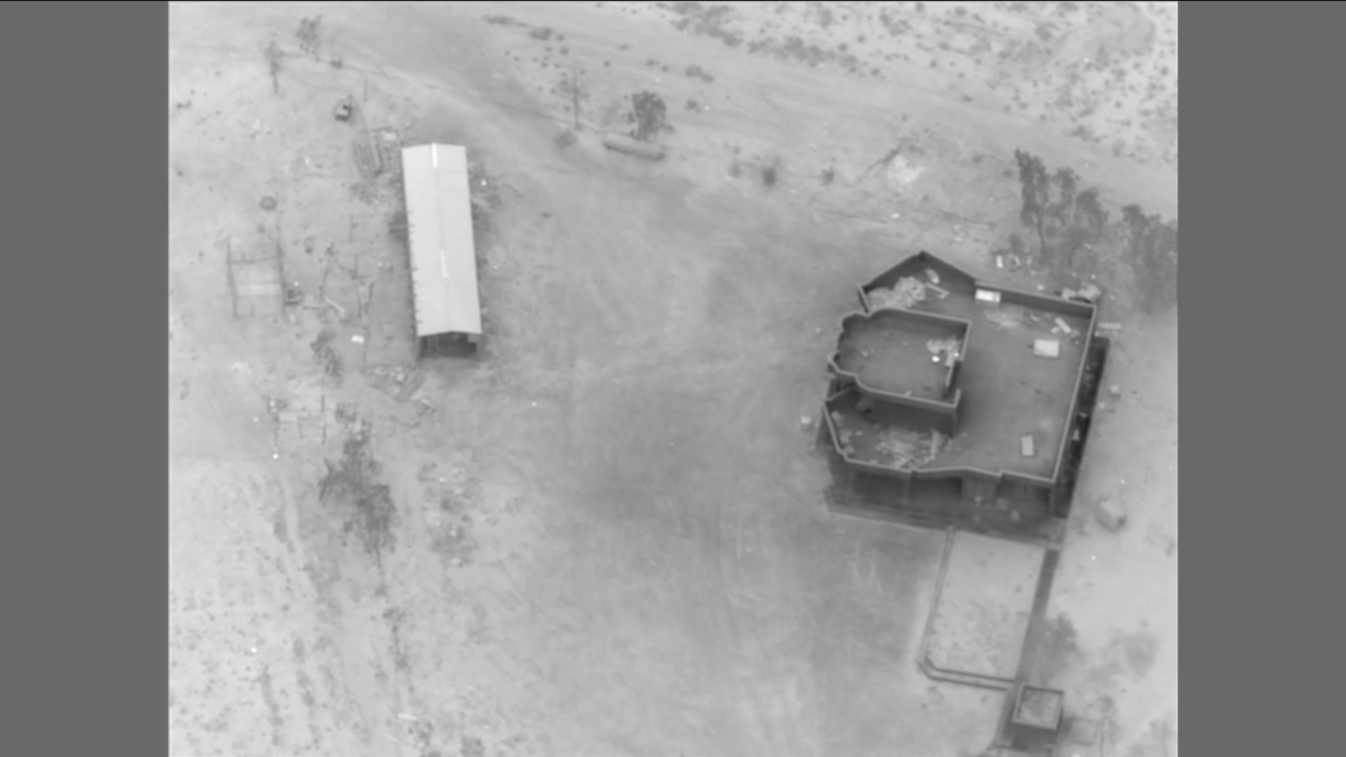 Black and white surveillance photo of a drone facility