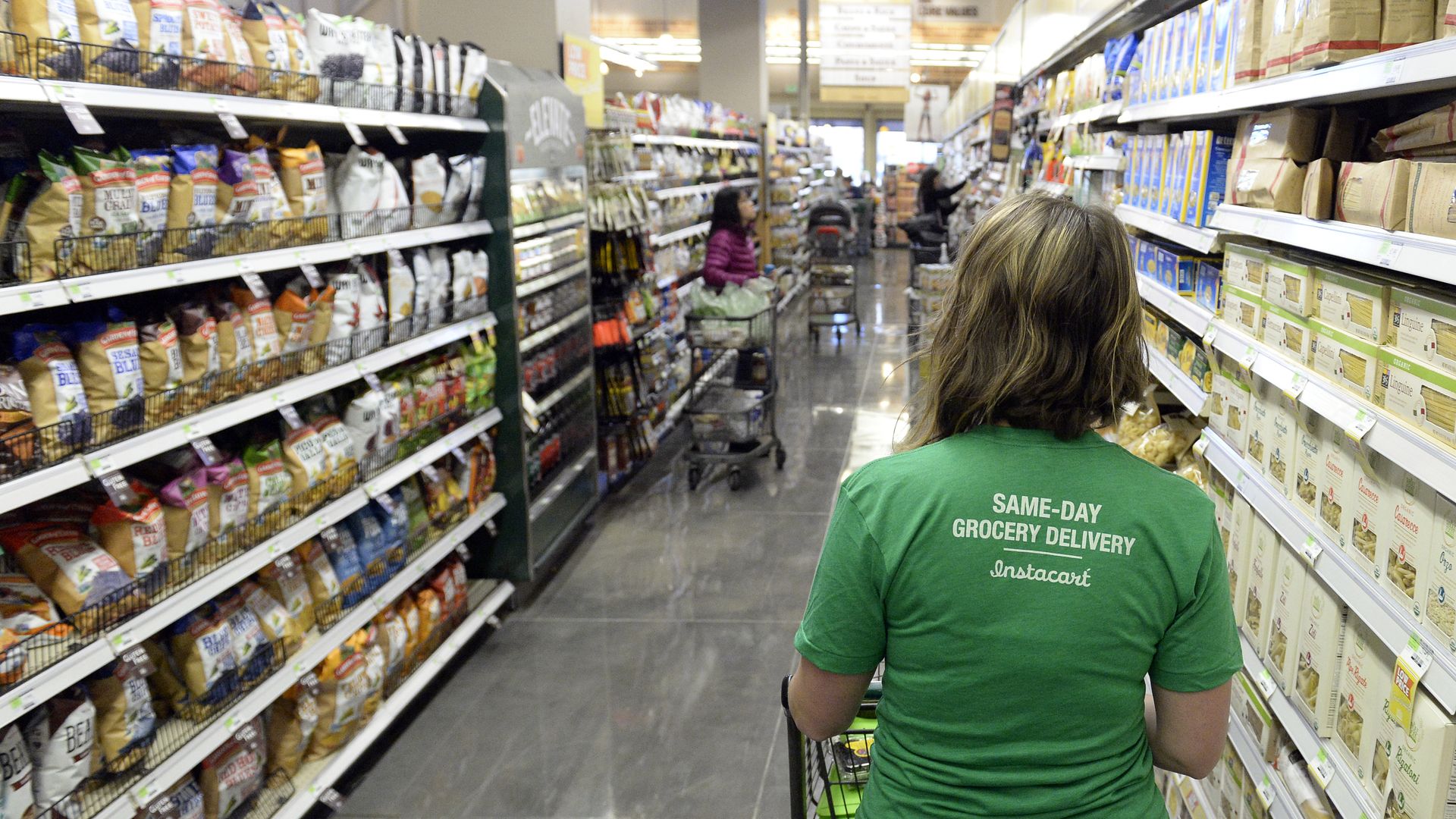 Instacart shopper in a grocery aisle.