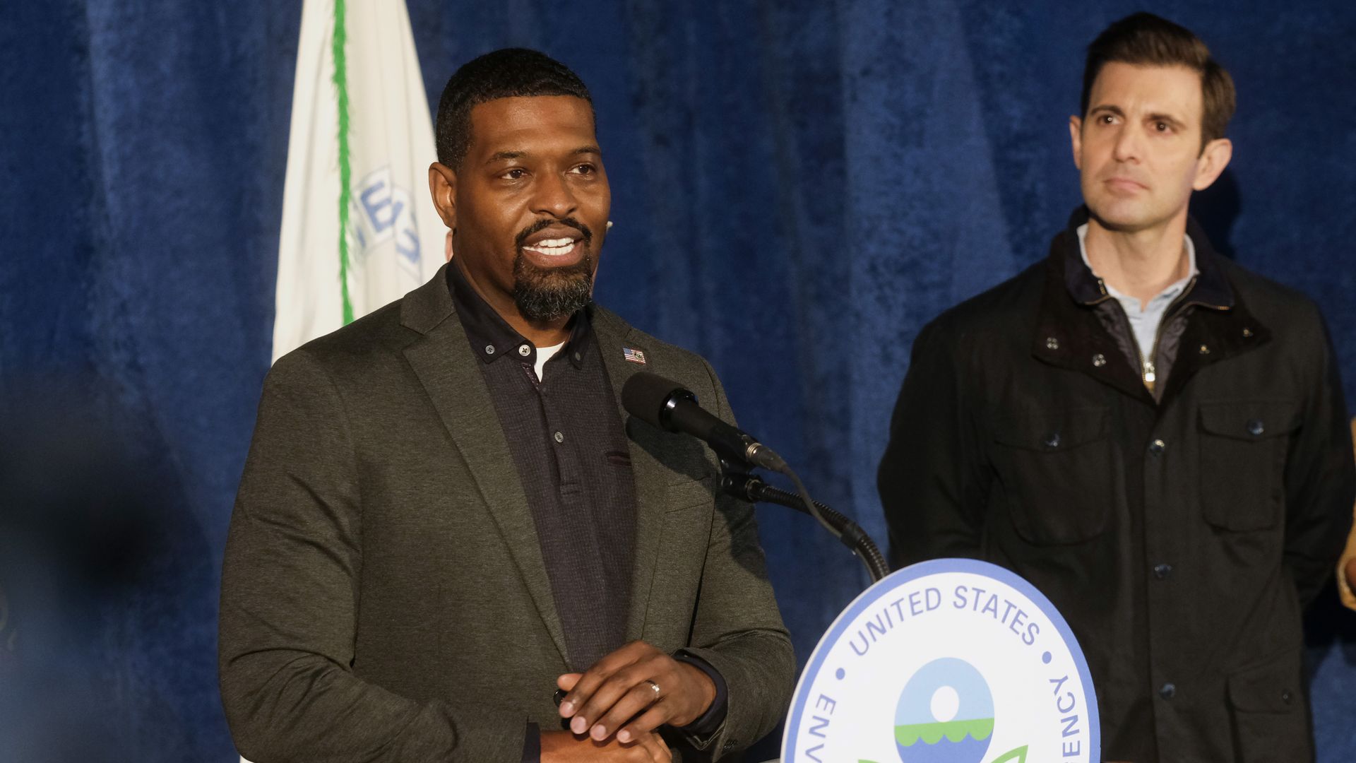 Photo of Michael Regan speaking from a podium