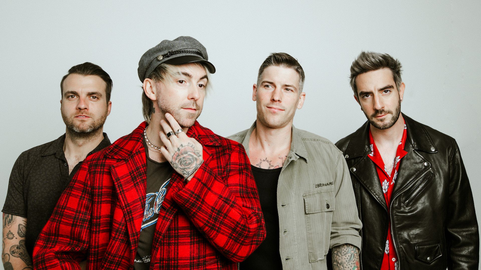 The members of rock band All Time Low pose for a photo.