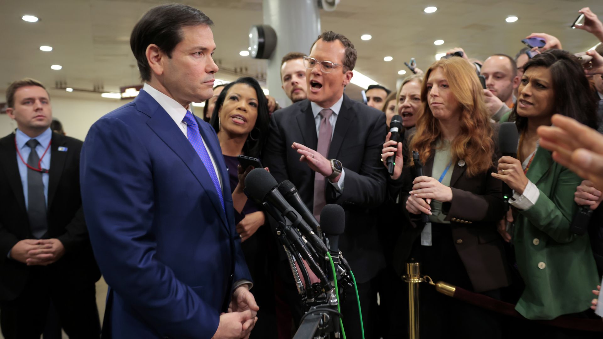 Man with mics and angry people