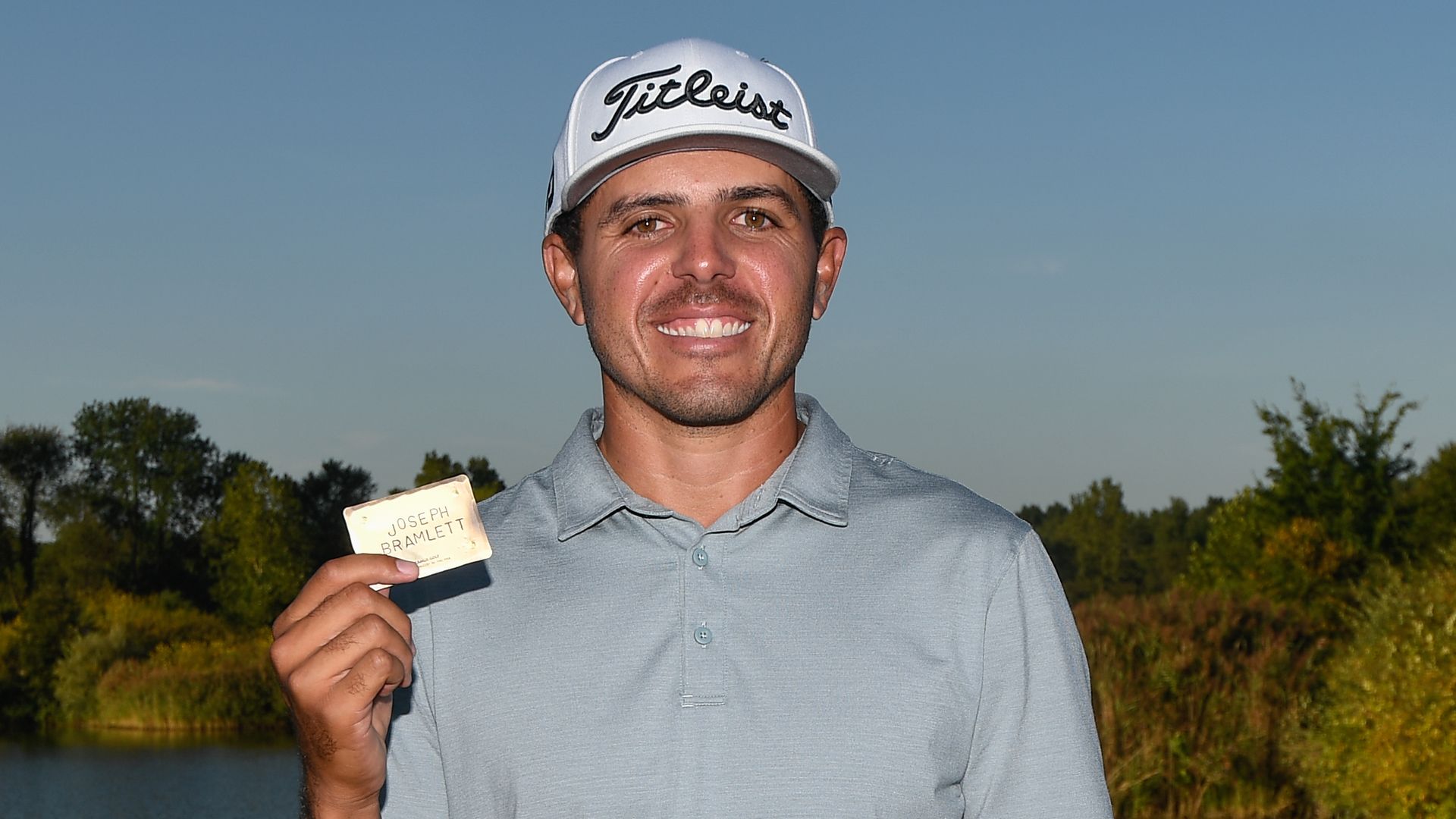 Joseph Bramlett holding his PGA Tour card
