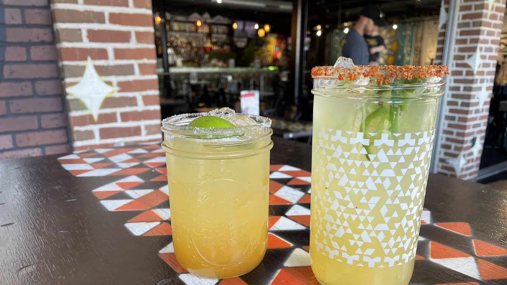 two margaritas sitting on a table