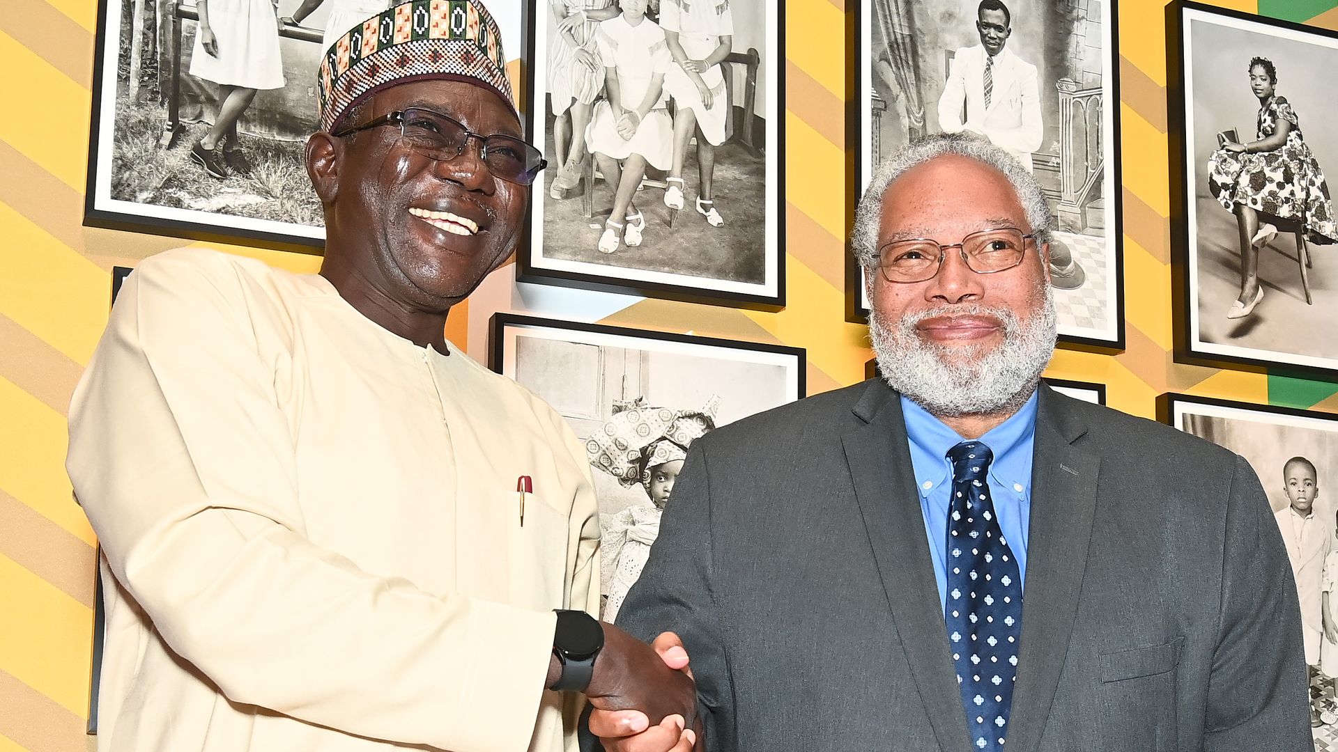 Dr. Abba Isa Tijani, a Nigerian professor, shakes hands with Lonnie Bunch fromthe Smithsonian at a repatriation ceremony at the National Museum of African Art on October 11 in Washington, DC. 