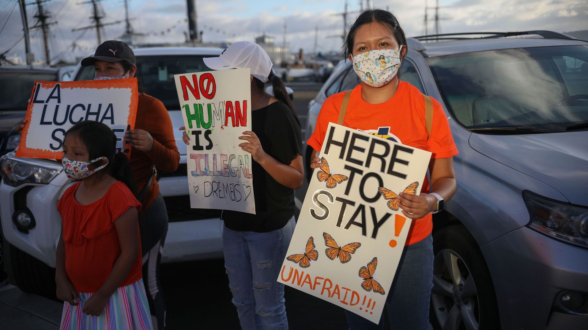 People hold signs during a rally in support of the Supreme Court's ruling in favor of the Deferred Action for Childhood Arrivals