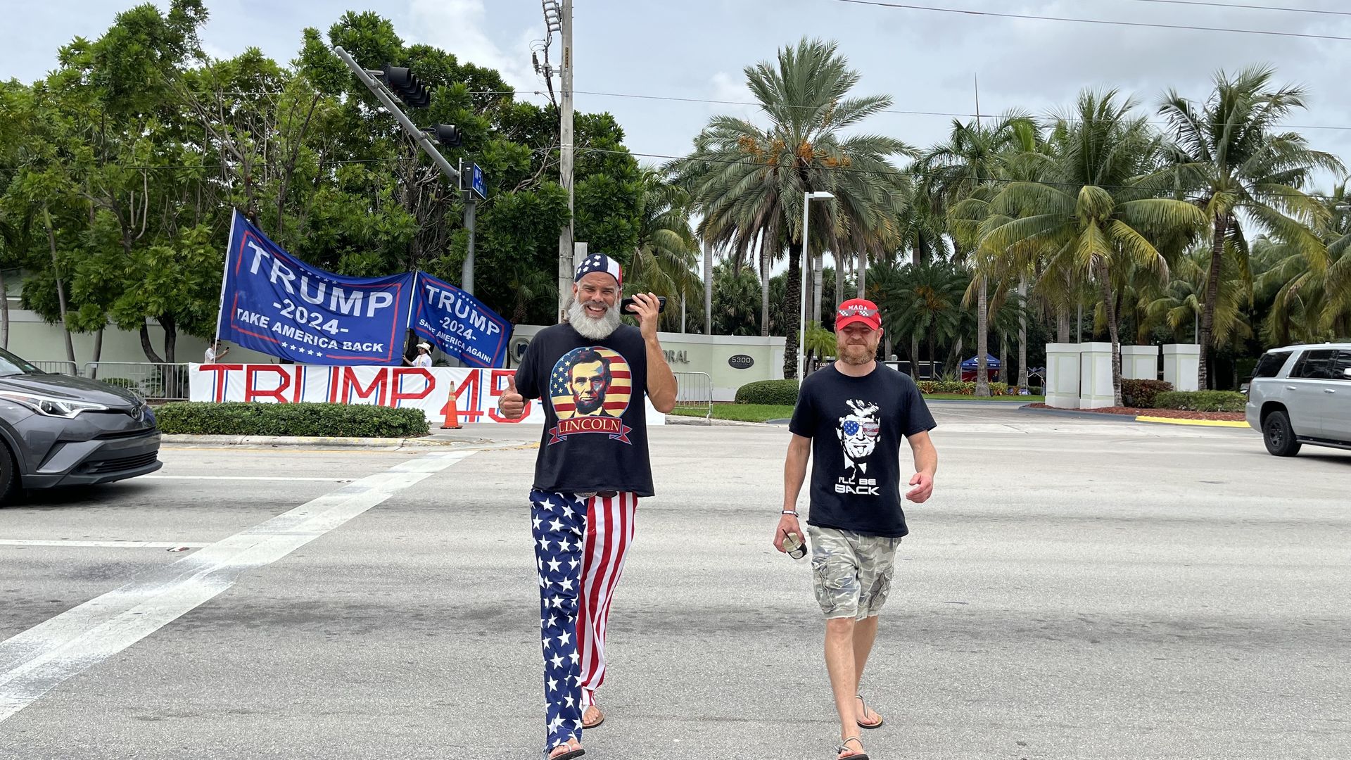 Two Trump supporters crossing the street.
