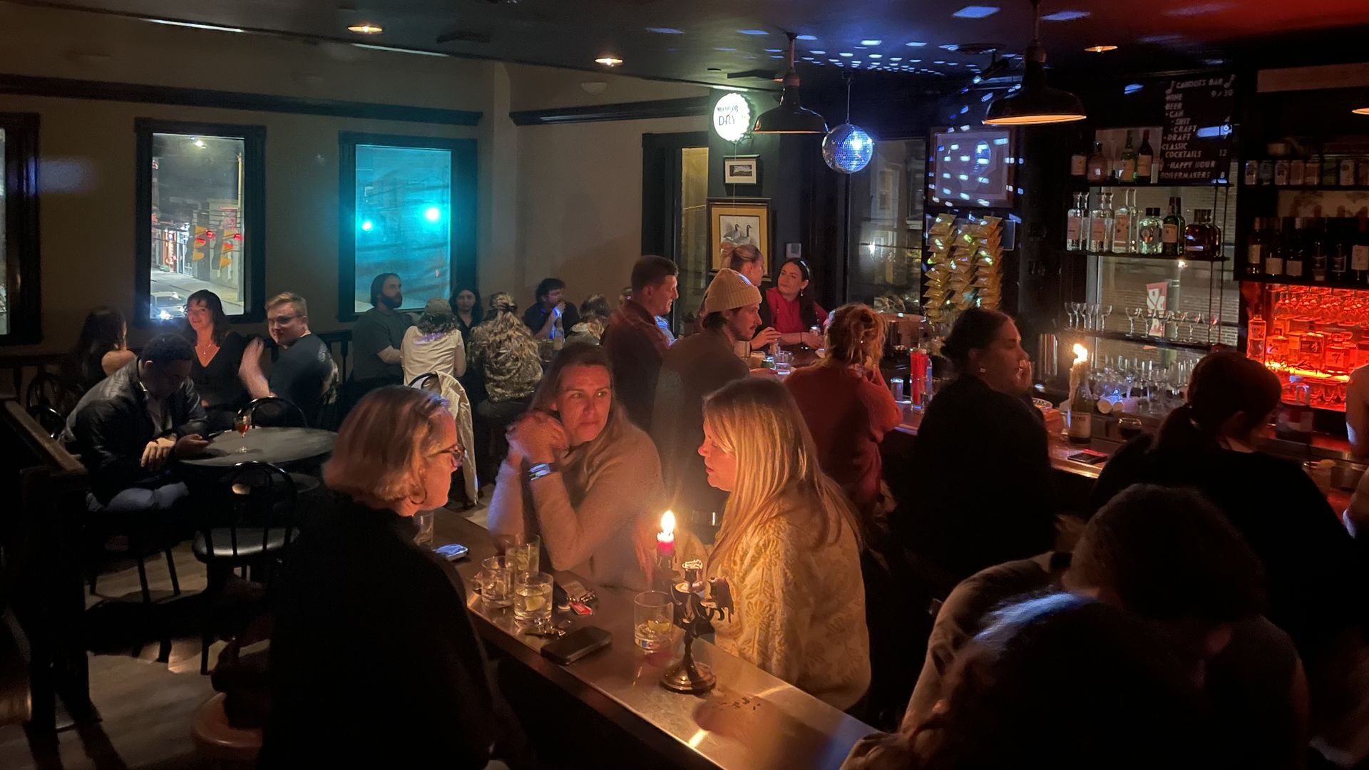 a bunch of people hanging in a swanky looking bar 