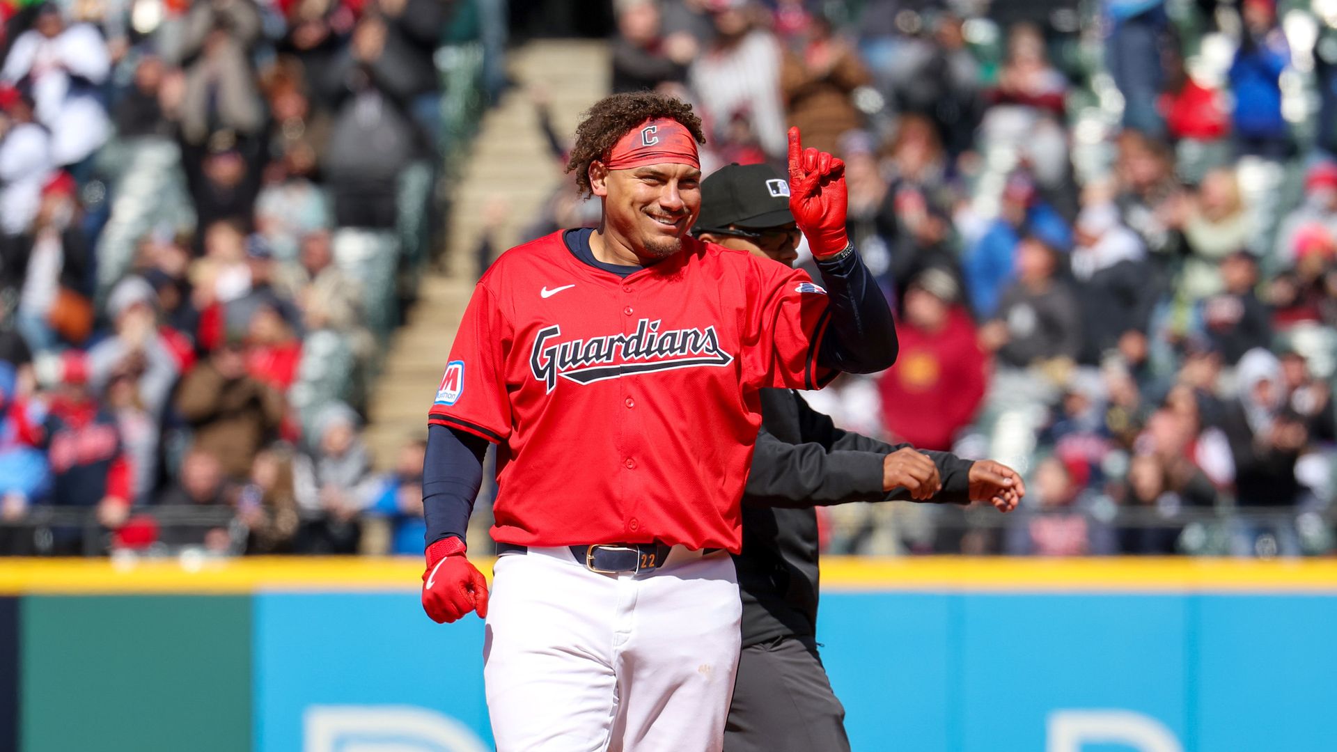 A Guardians player holds up a finger while on the bases.