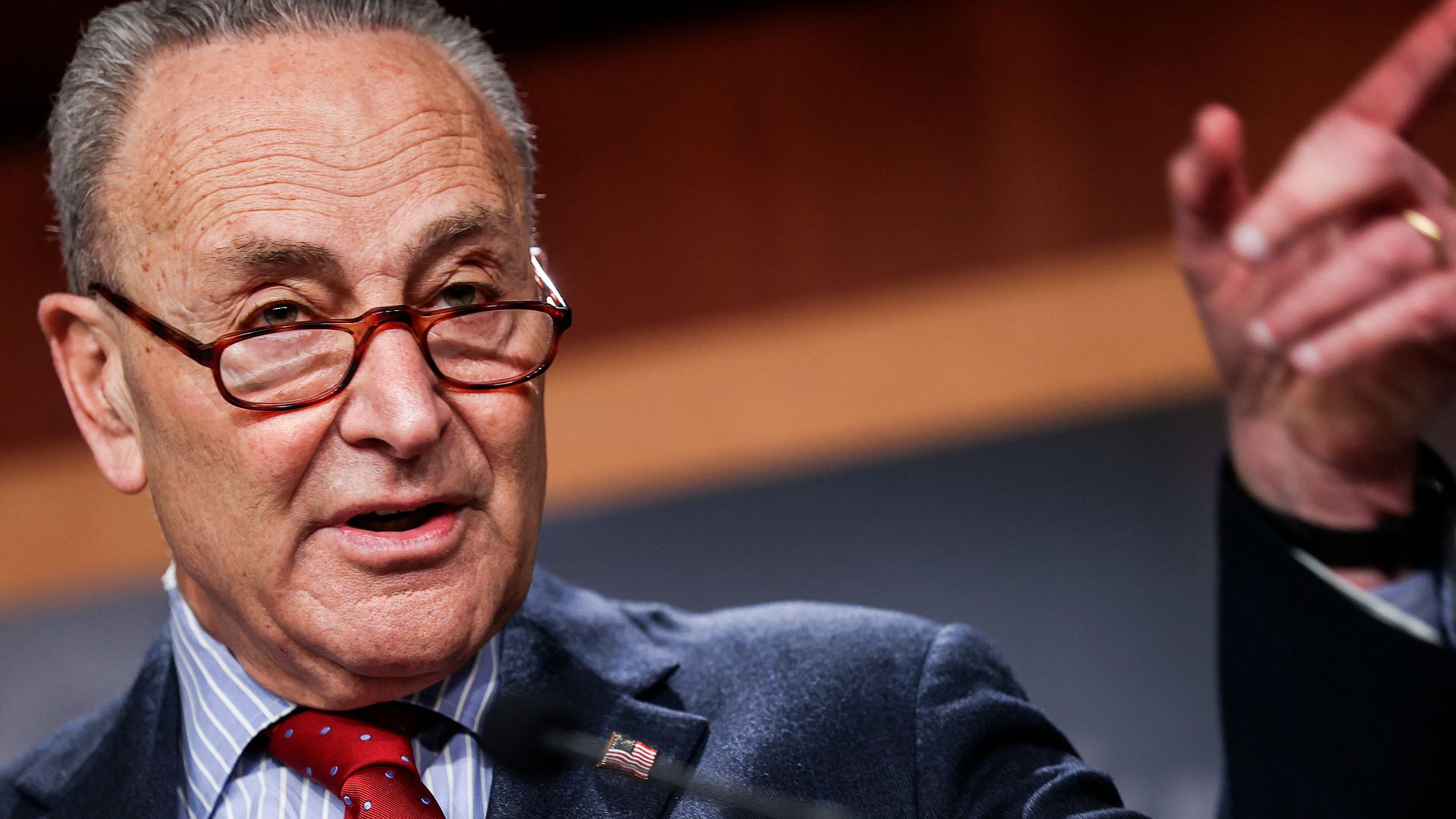 Photo of Chuck Schumer raising a pointed finger while speaking