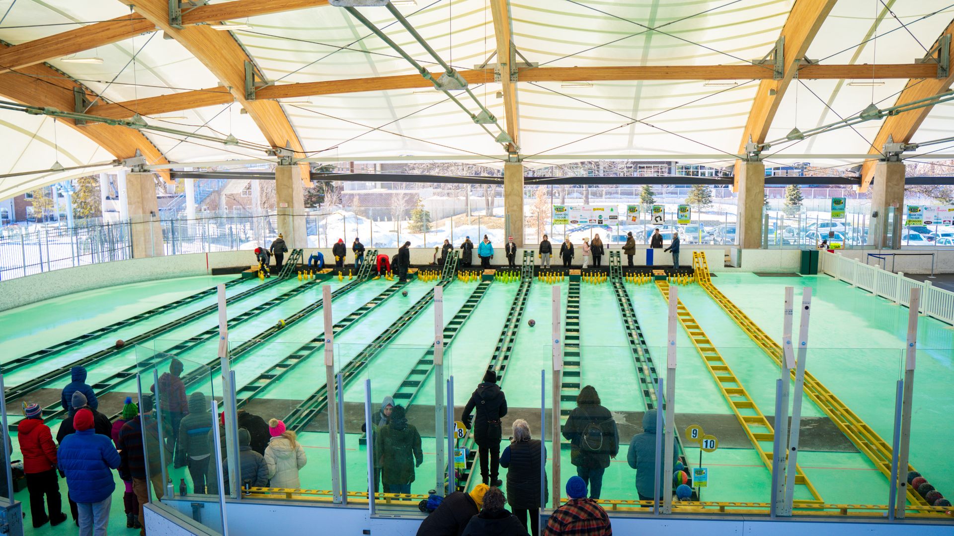 A bowling alley with green ice lanes.