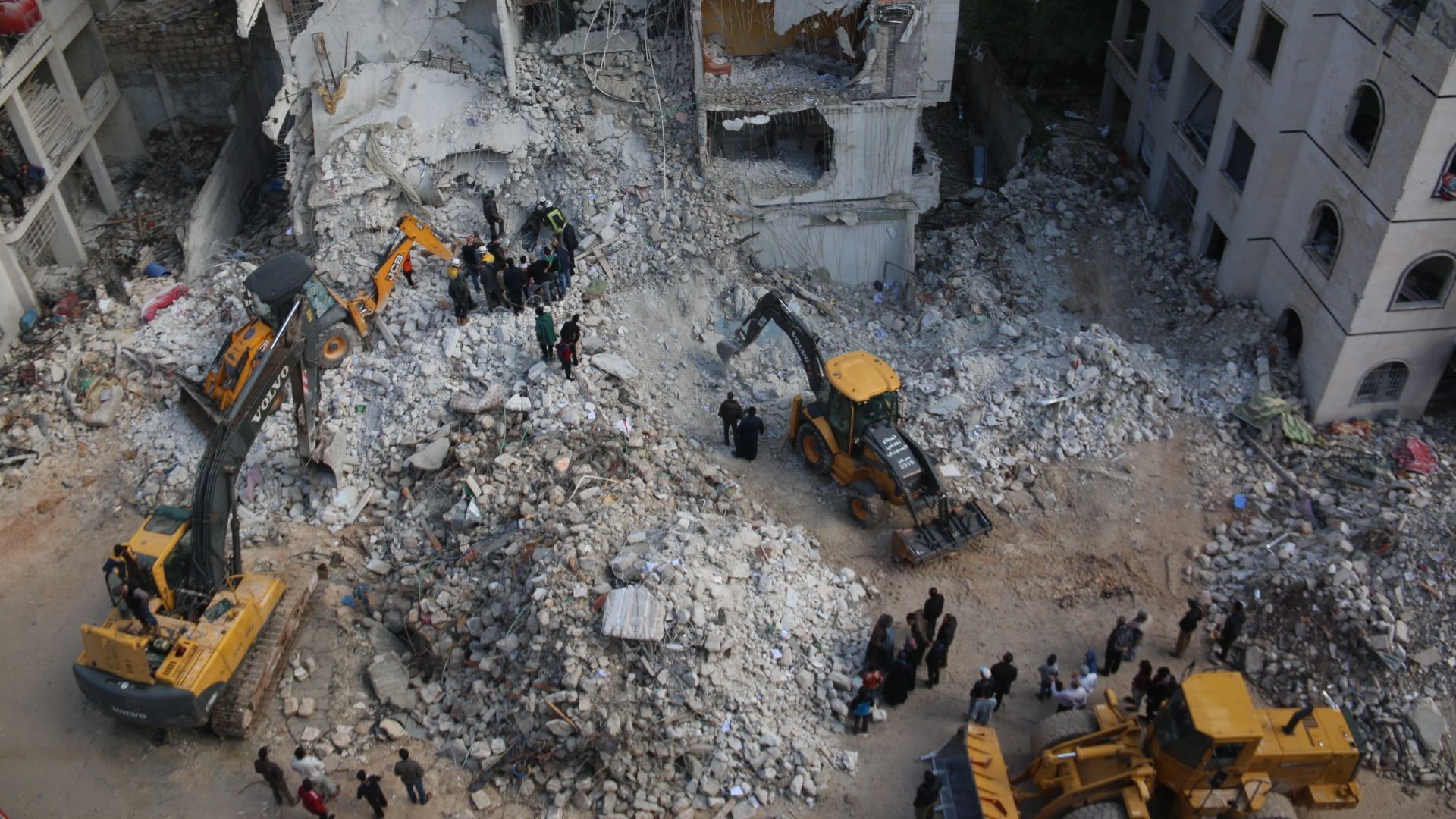 Syrian civil defense members conduct search and rescue operations at the site of the blast in Idlib on April 10, 2018