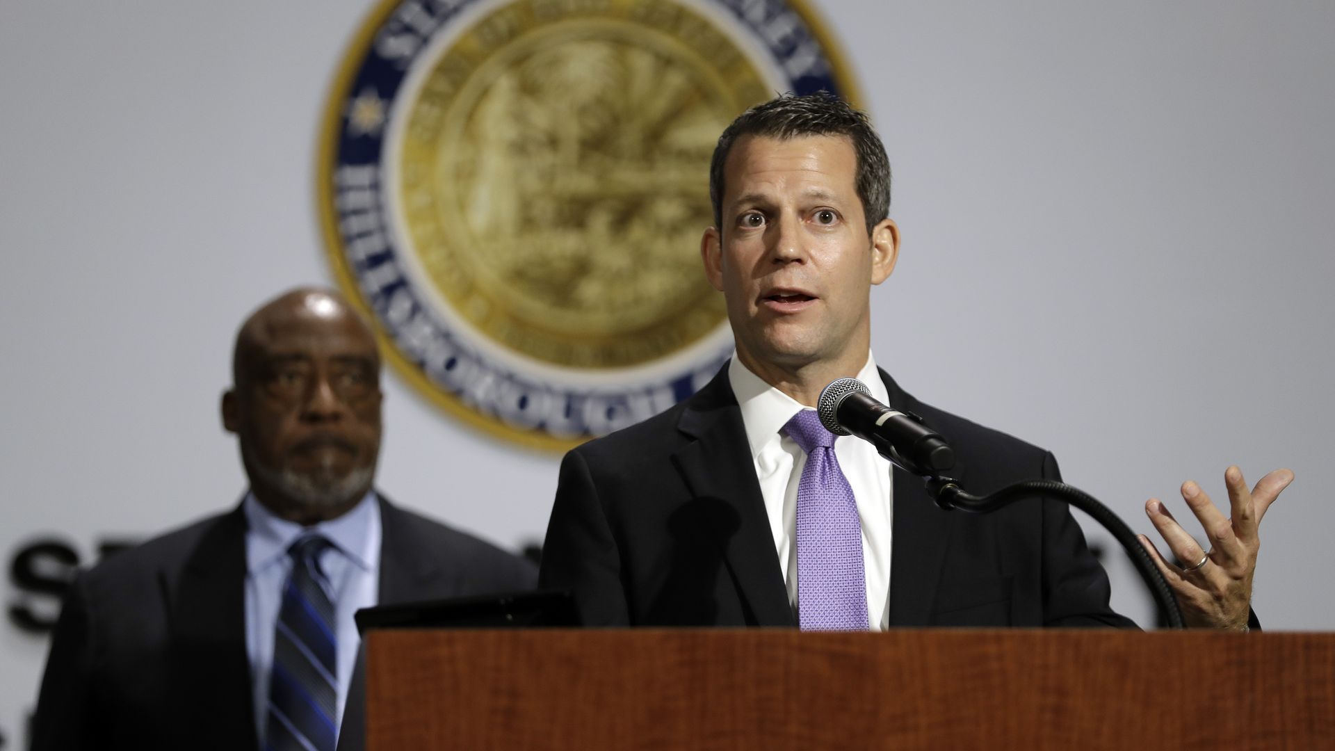 Hillsborough State Attorney Andrew Warren speaks at a podium.