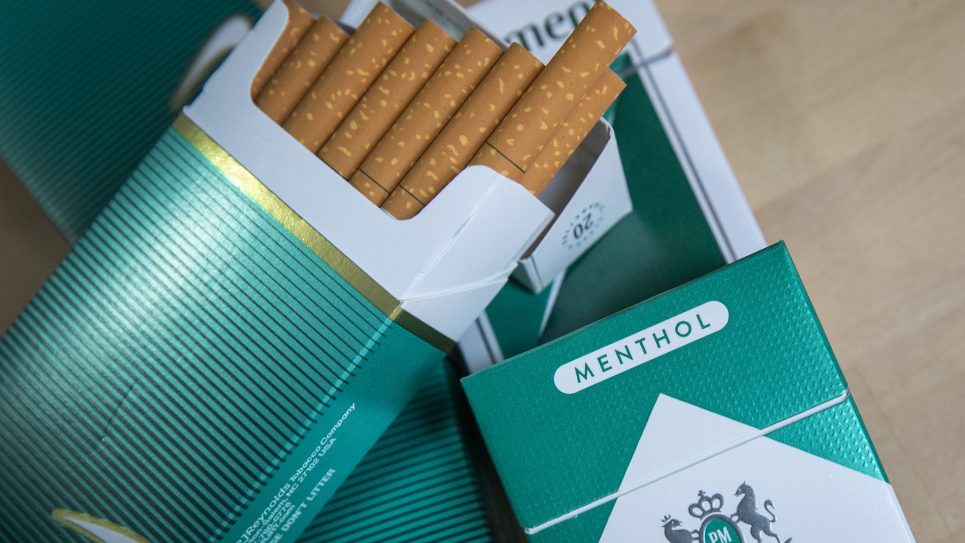 An open pack of menthol cigarettes sitting on top of a closed one