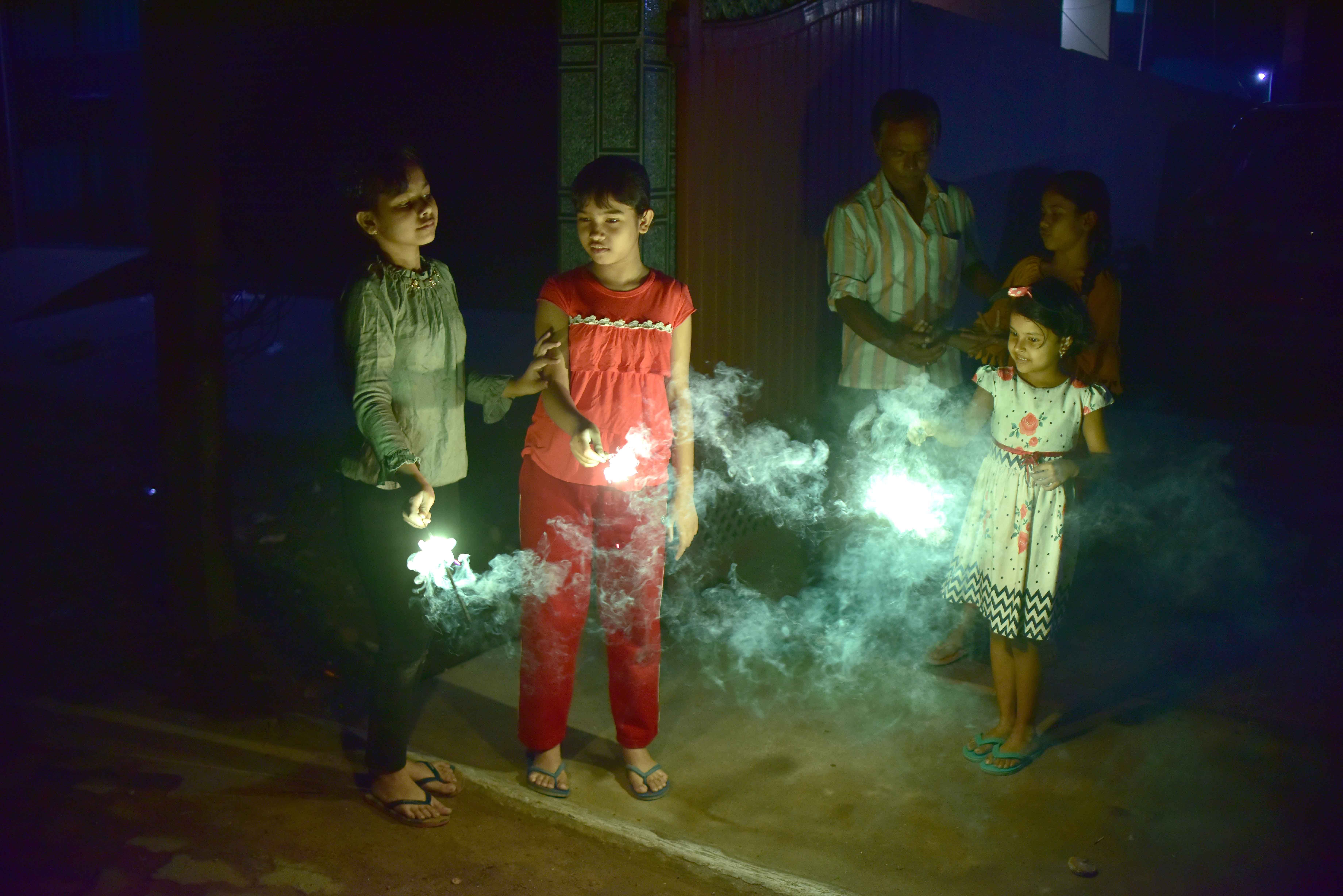 Girls holds sparklers during Diwali, the Hindu festival of lights in Nagaon District of Assam ,india