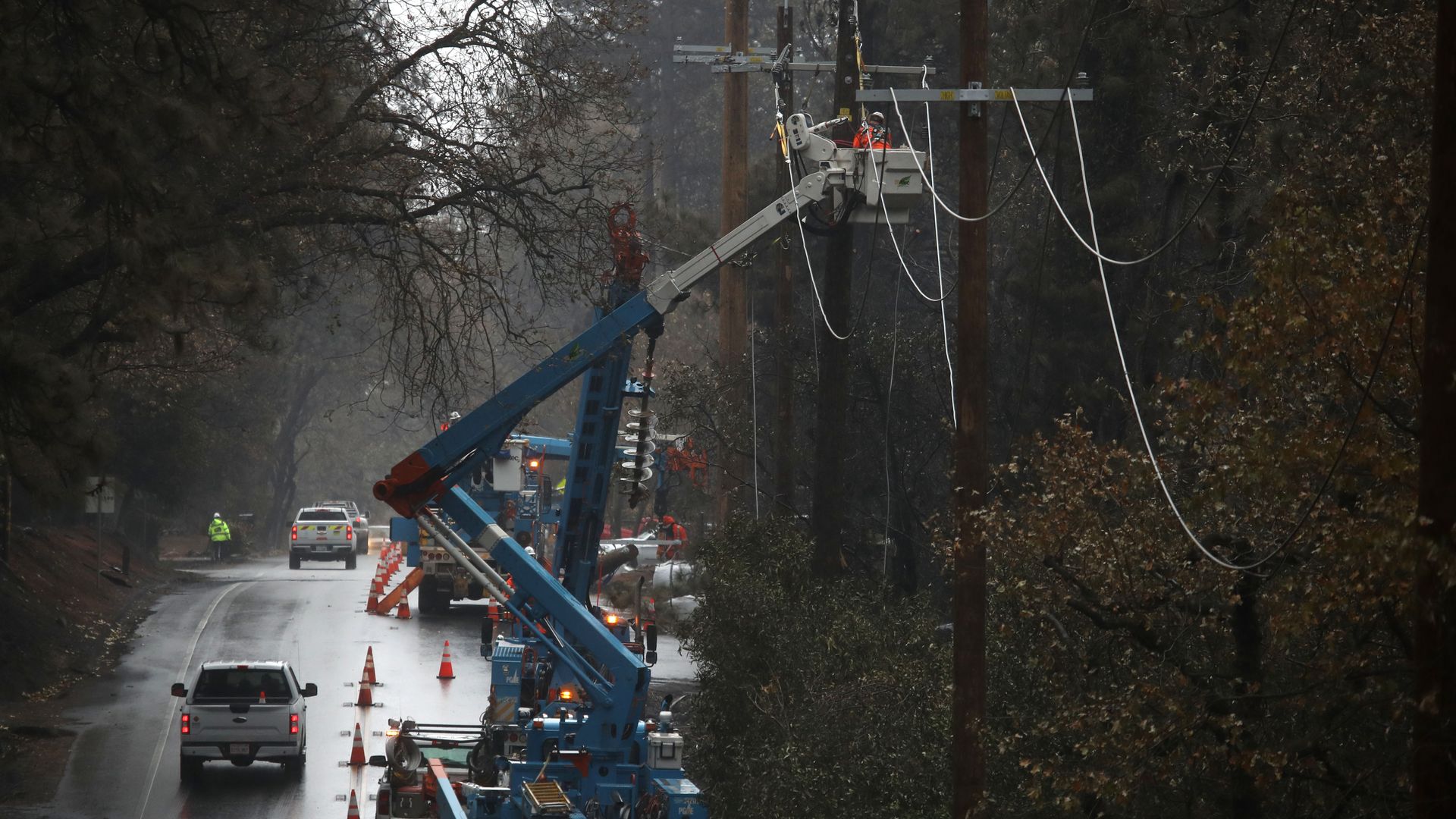 Pacific Gas and Electric (PG&E) crews repair power lines that were destroyed by the Camp Fire