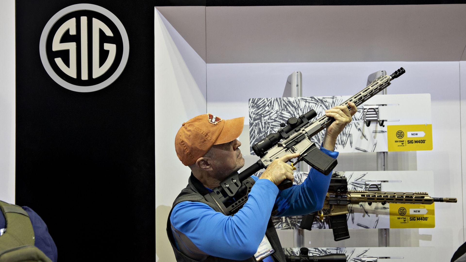 Man at a convention with a rifle