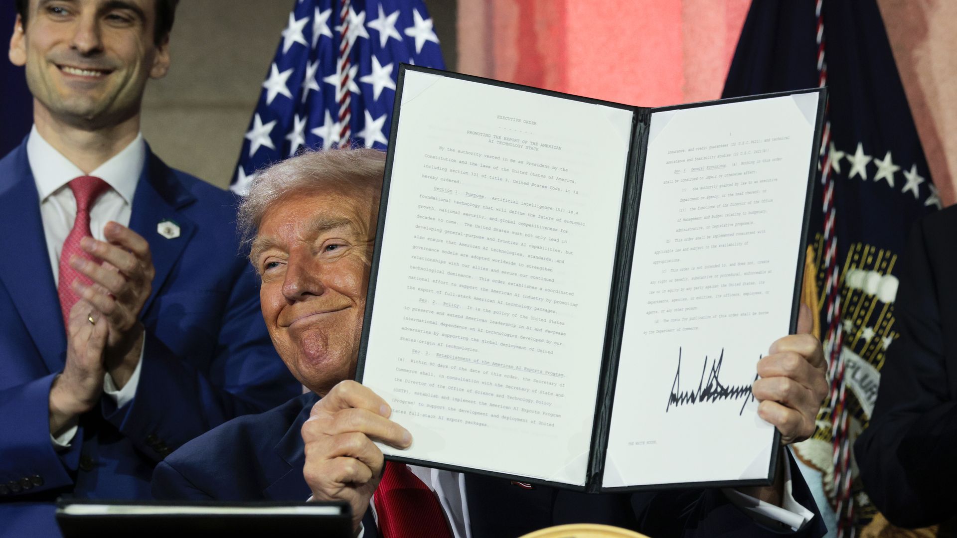 U.S. President Donald Trump displays a signed executive order relating to his AI Action Plan on July 23, 2025.