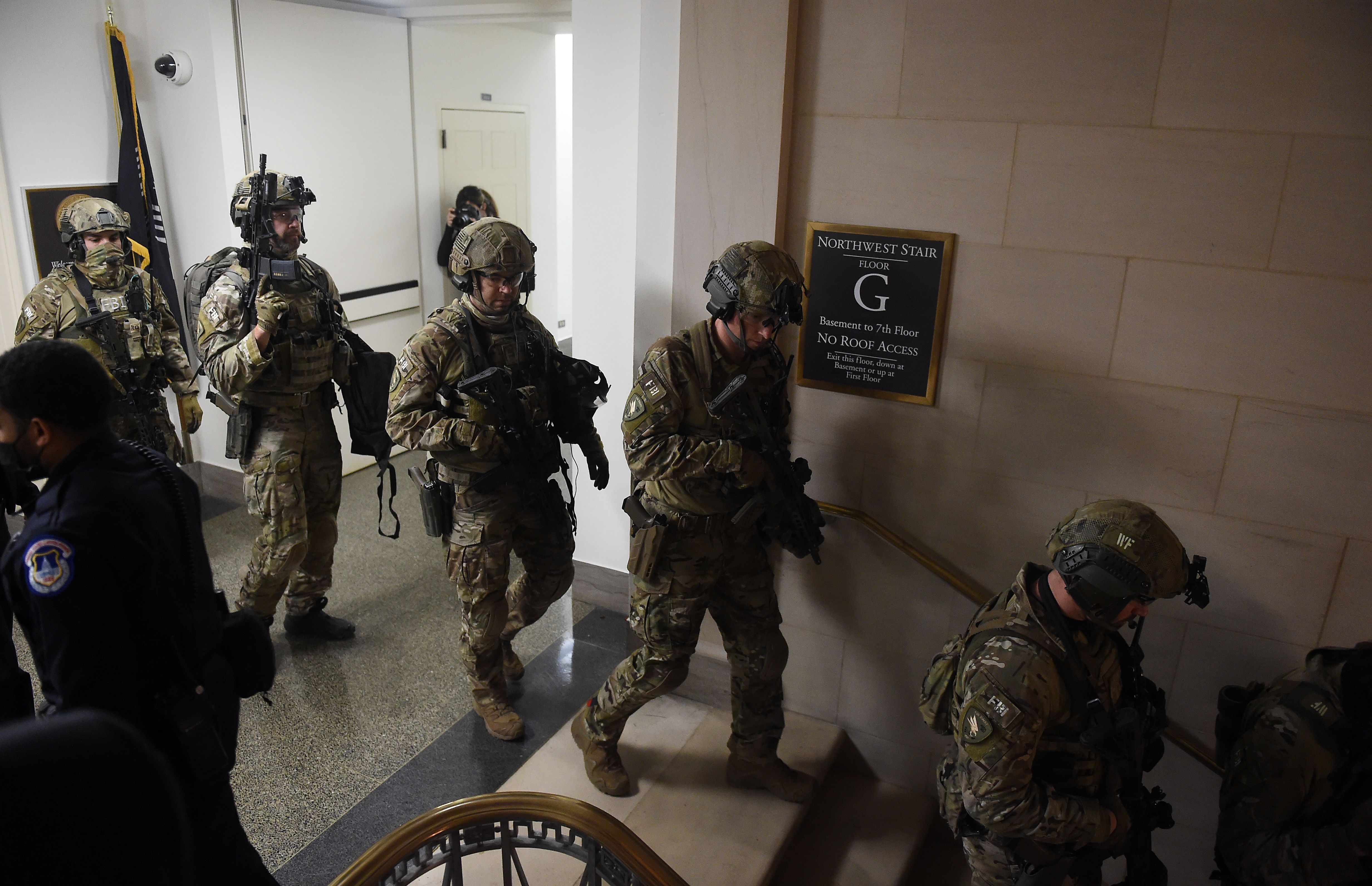 Members of the FBI Swat team secure the corridors of the US Capitol in Washington, DC on January 6, 2021