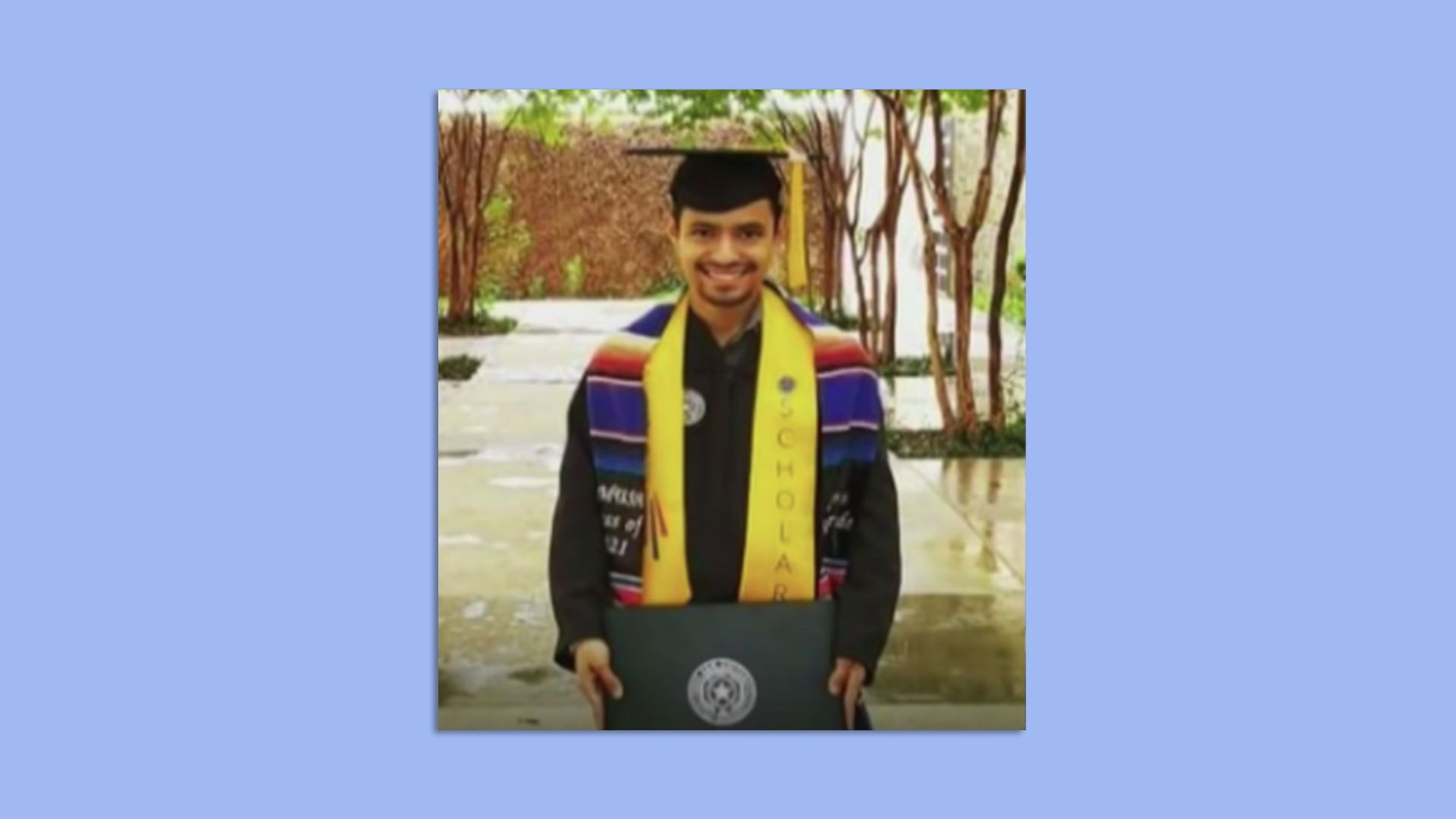 Carlos Conejo, 23, in his cap and gown with his honors and Hispanic heritage stoles. 