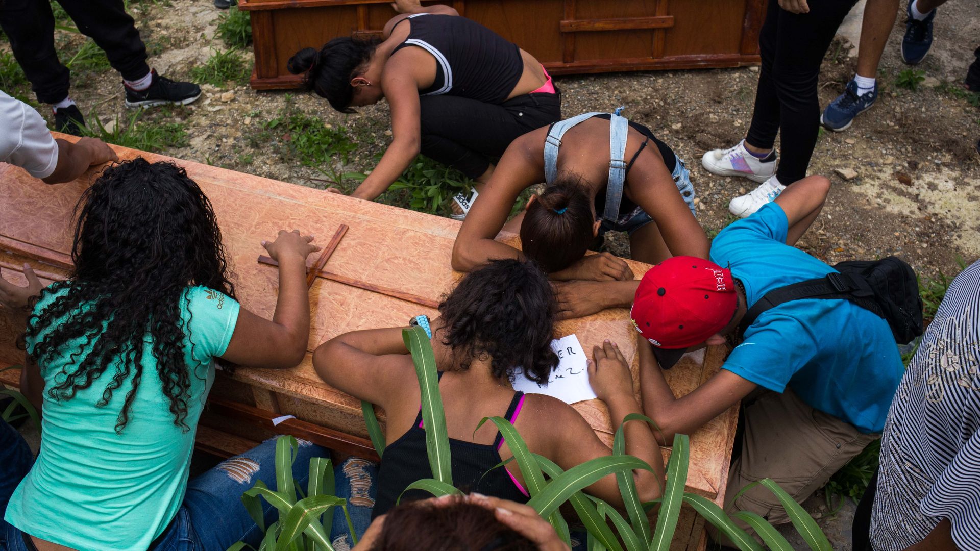 Relatives and friends mourn at the burial of Johander Perez and Wuilkerman Ruiz, at the General South Cementery in Caracas, Venezuela, on November 5, 2019.