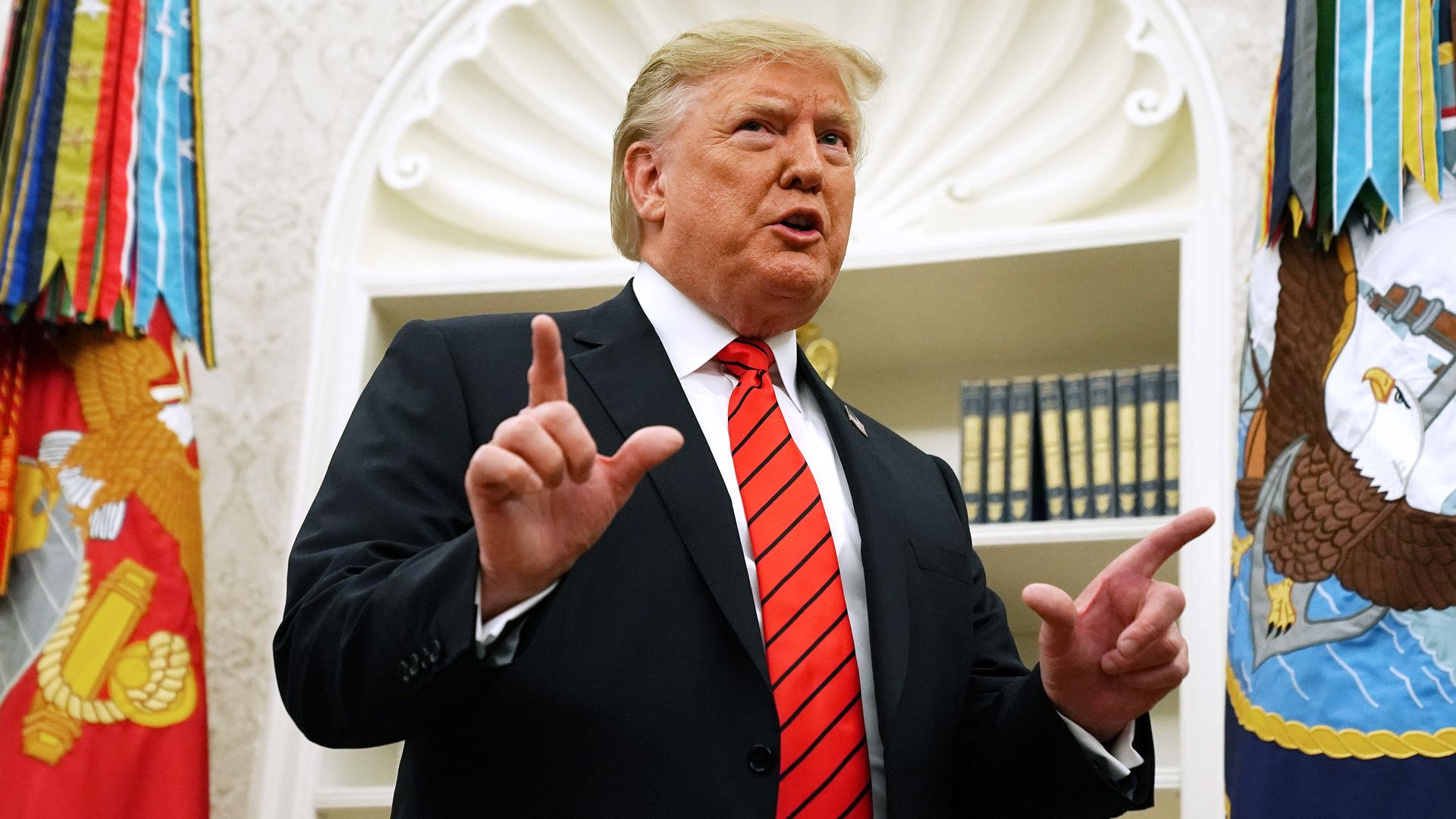 Trump with his hands pointing outwards.