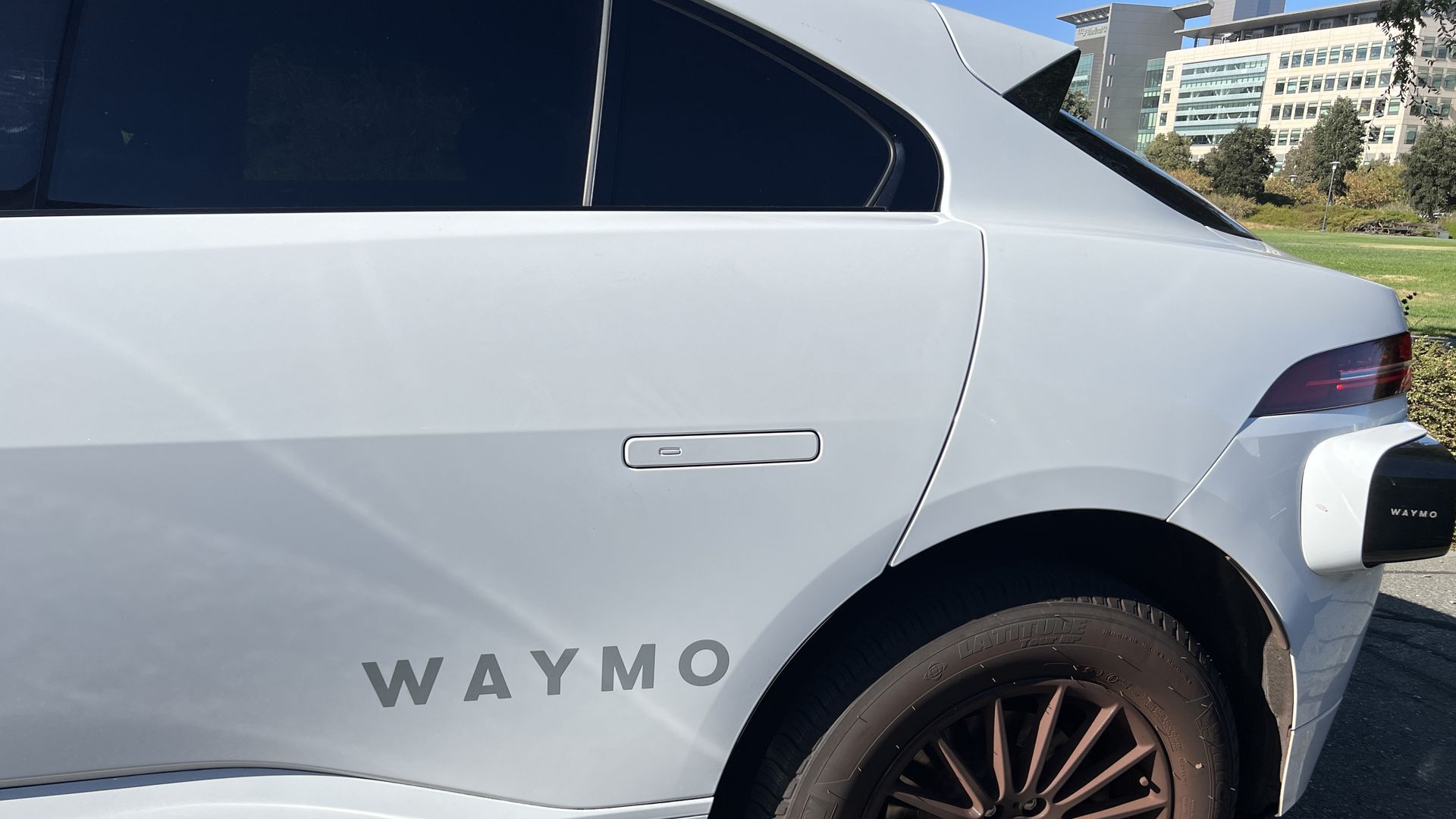 A photo of a car with the words "Waymo" on the side.