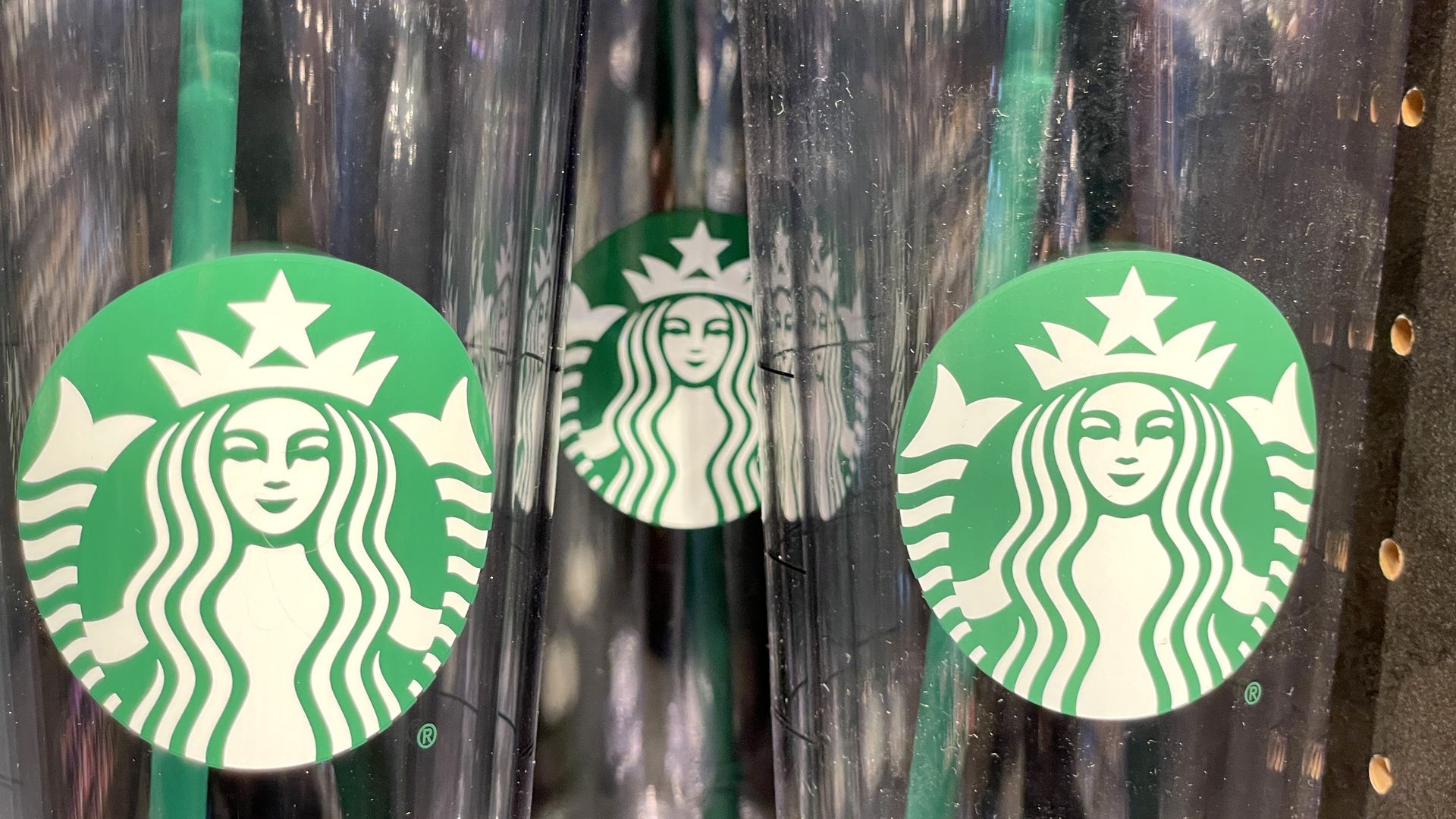 Clear Starbucks cups with green labels and straws