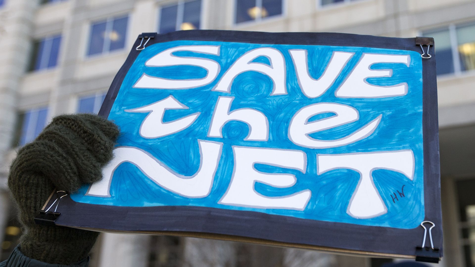 Protest sign reading "Save the Net"