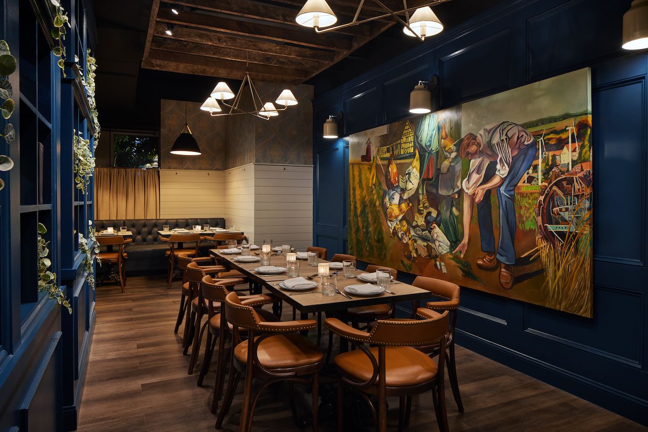 A dining room with a farm mural 