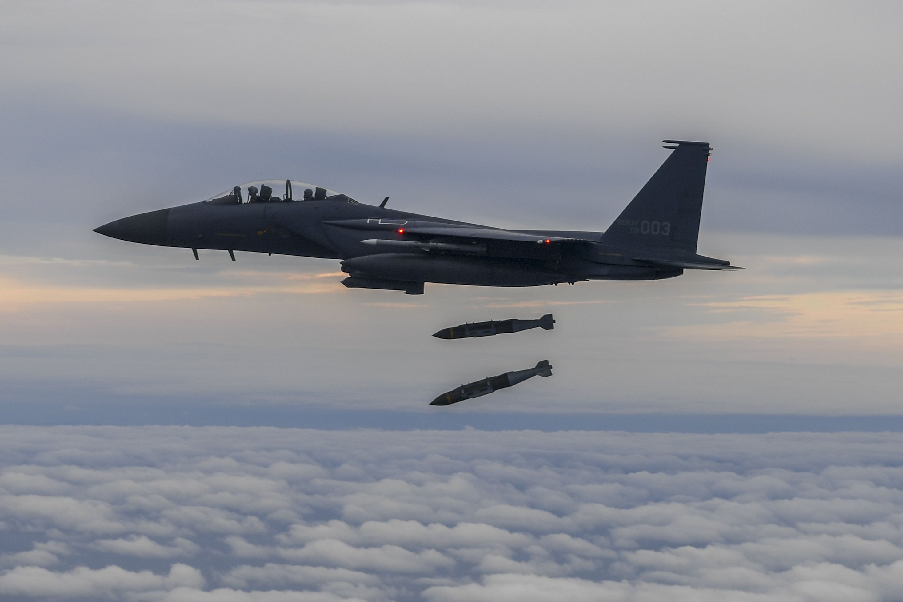 A South Korean F-15K fighter fires two bombs into an island target in response to North Korea's intermediate-range ballistic missile (IRBM) launch earlier in the day on Oct. 4.