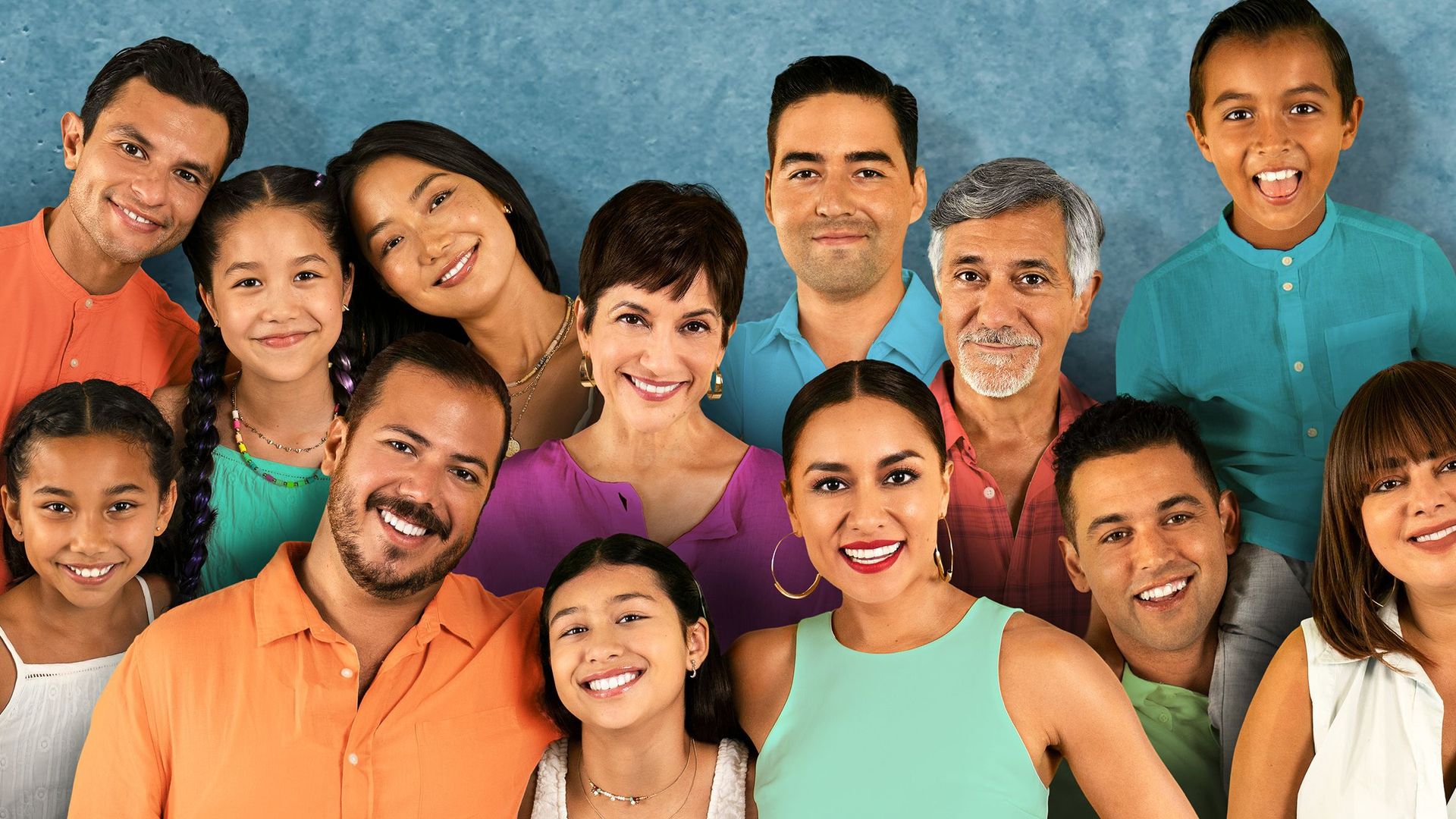 Actors for the show "The Garcias" pose for a portrait. All are smiling and wearing various jewel tones. 