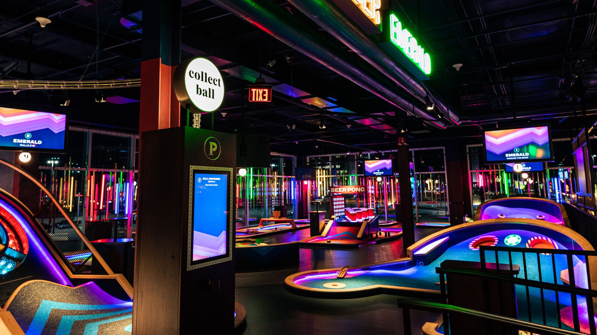 An overview photo of one of Puttshack's neon-colored mini golf courses