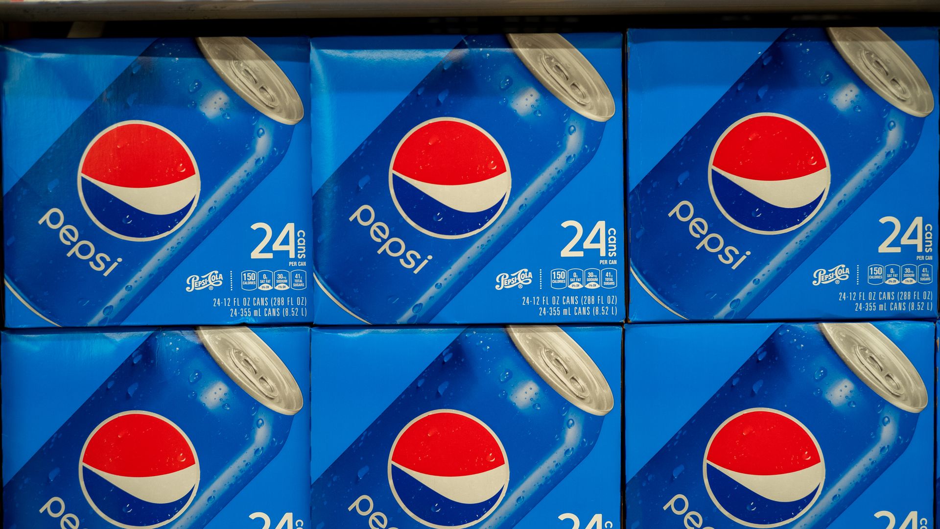 Boxes of pepsi cans in a row stacked