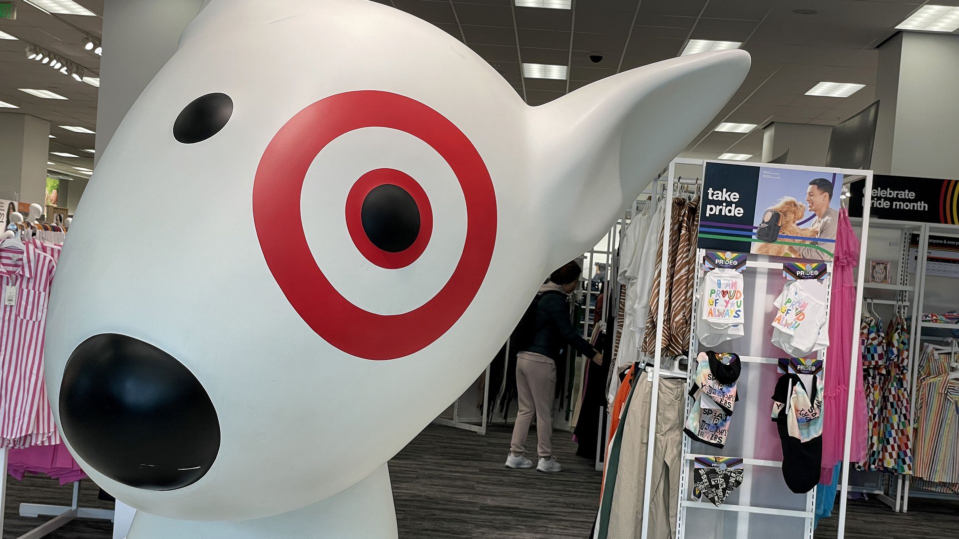 Target dog mascot near a Pride Month display that reads "Take pride"
