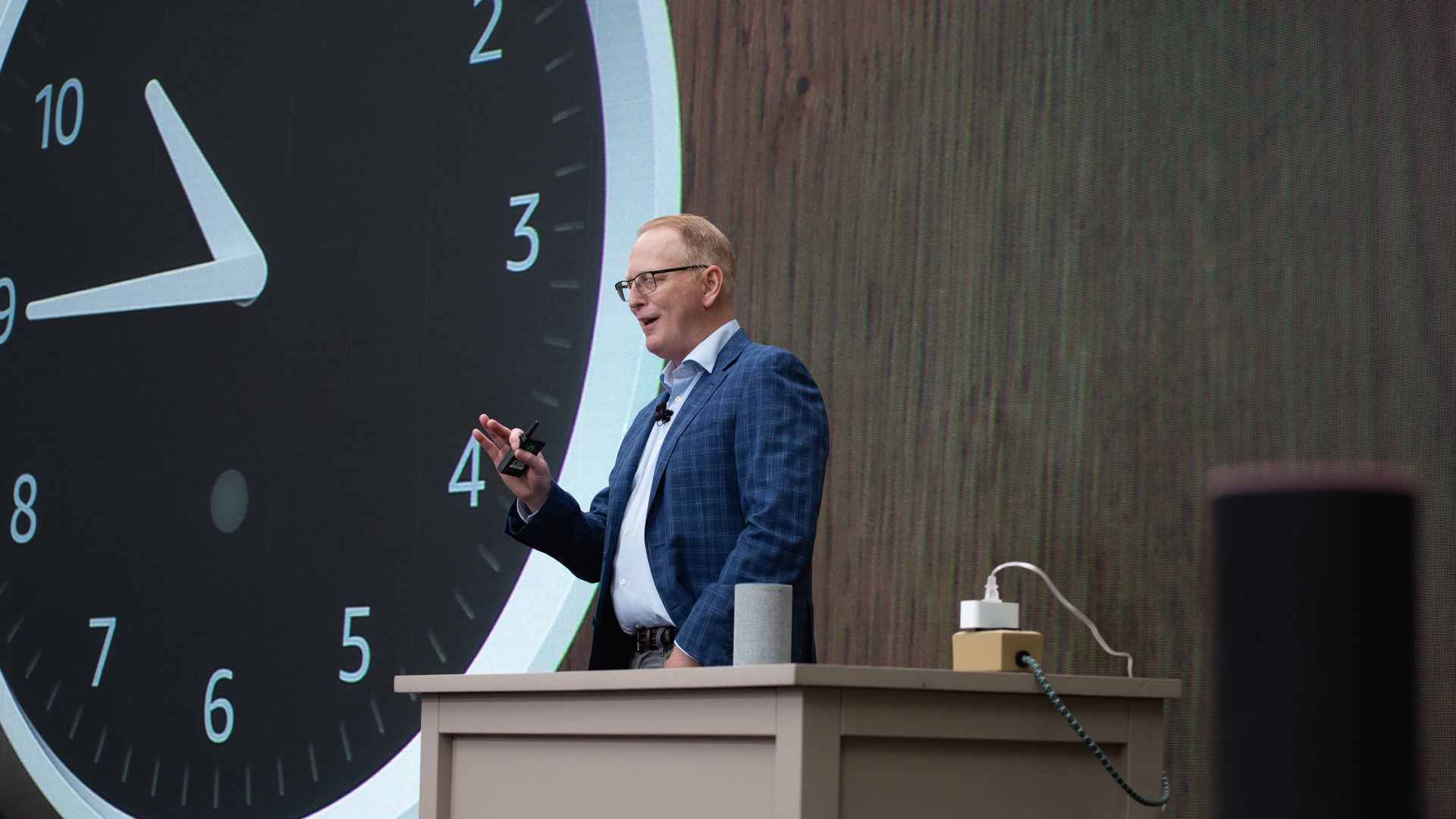Man standing in front of a new Amazon alexa powered clock.