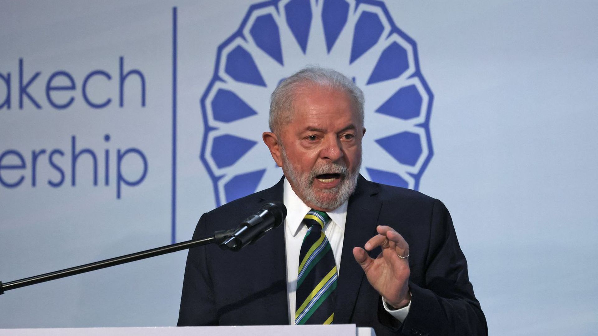 Brazilian President-elect Luiz Inácio Lula da Silva speaks in front of a microphone while looking out a crowd at COP27 in Egypt