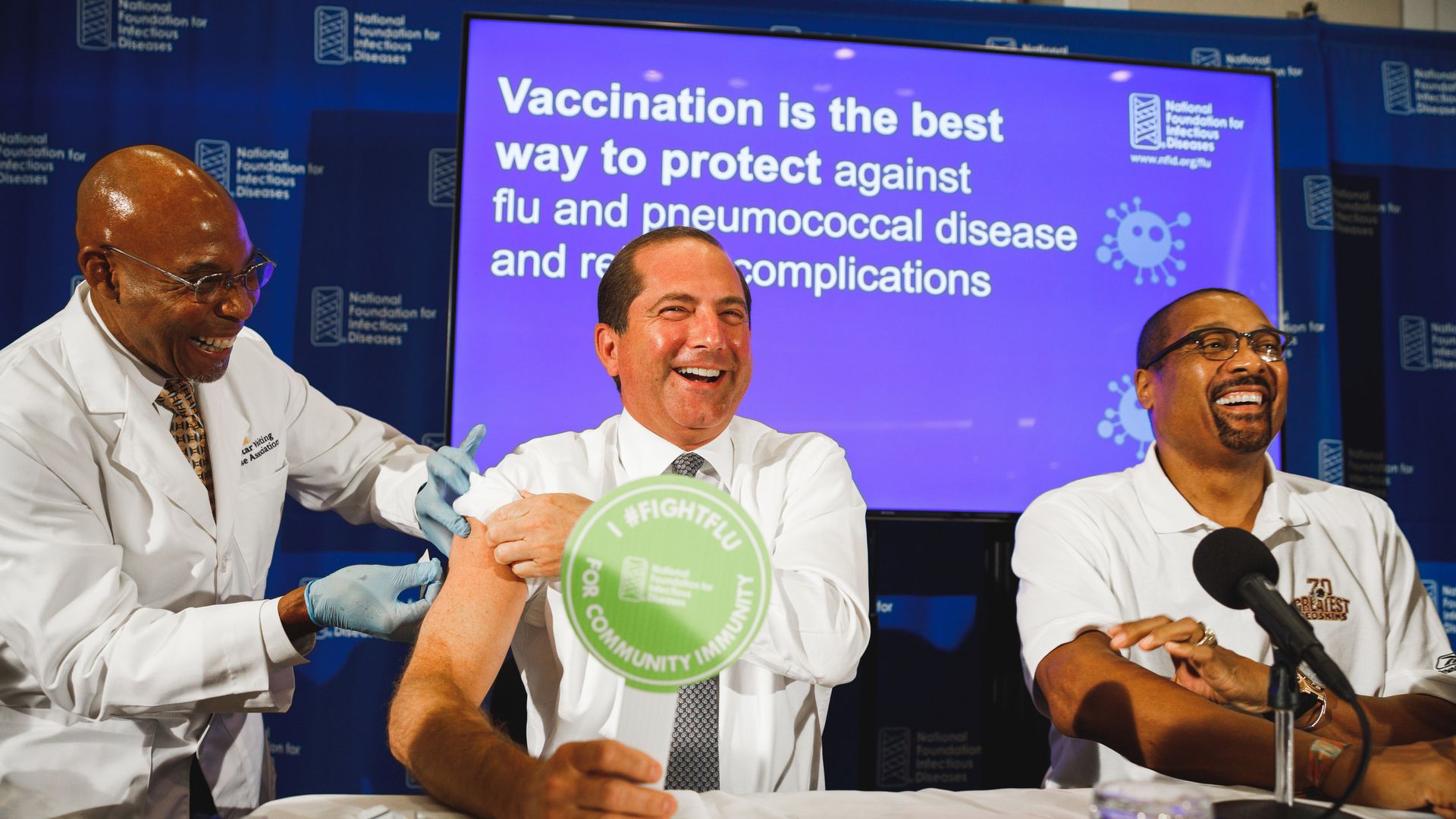 Photo of HHS Secretary Alex Azar smiling as he receives his flu shot
