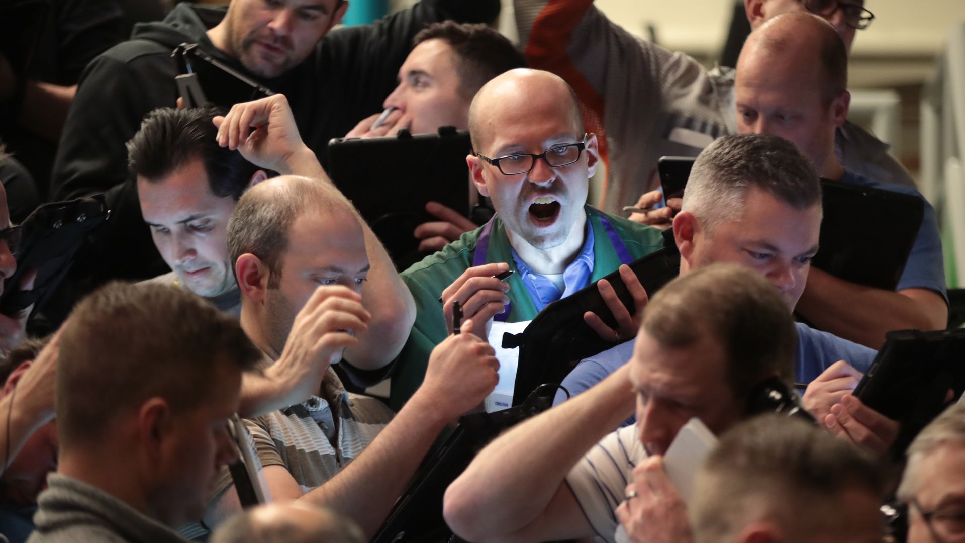 Traders fill orders in the S&P options pit near the close of trading in Chicago, Illinois on January 31, 2020. 