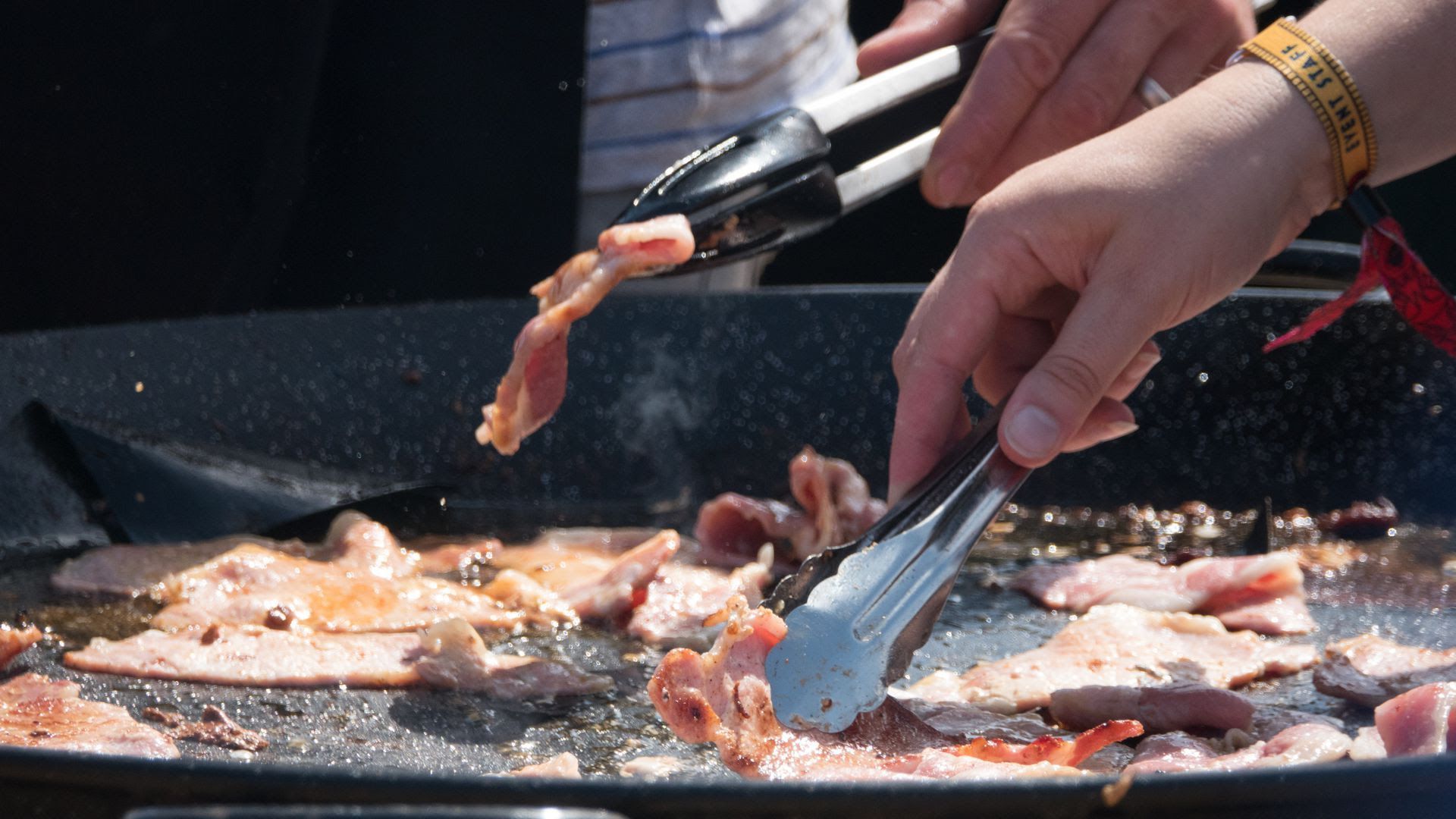 People frying bacon