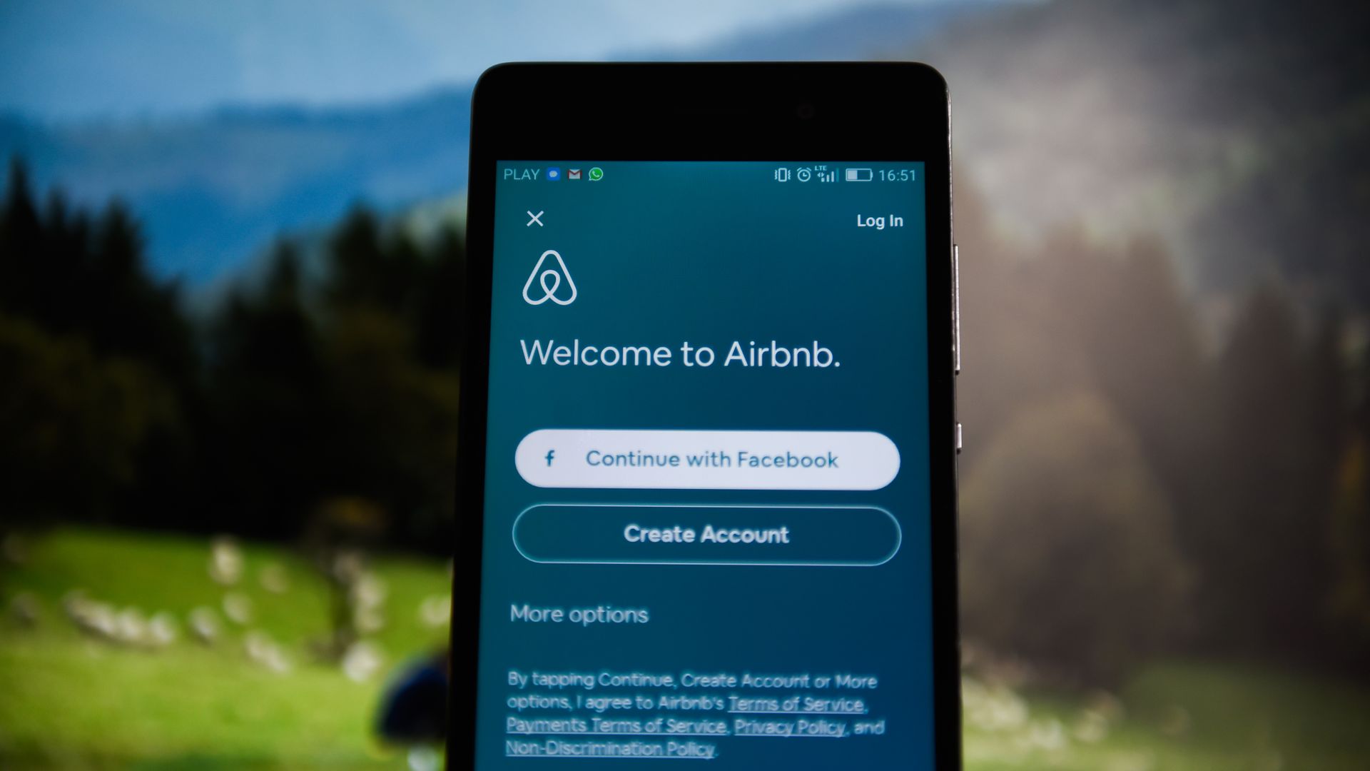 A phone with the airbnb app opened.
