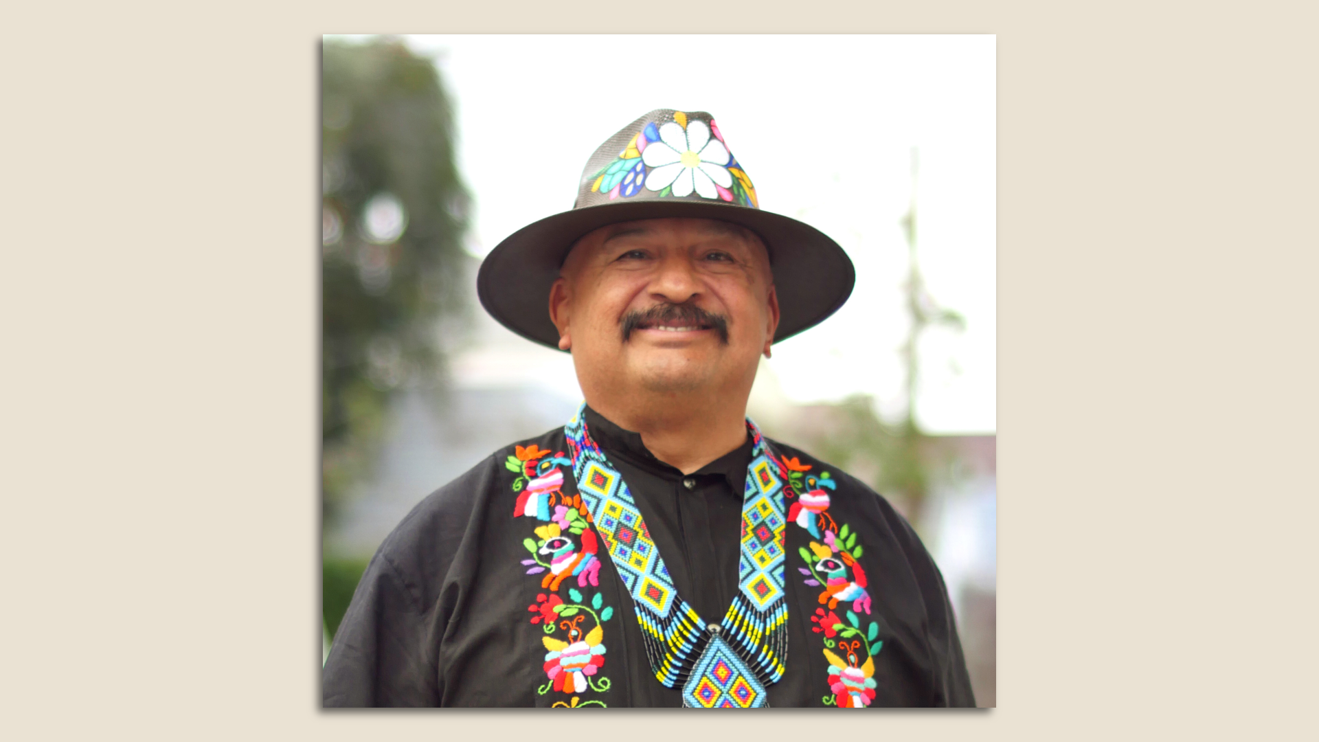 Photo of Roberto Hernandez smiling at the camera while dressed in traditional Mexican garb
